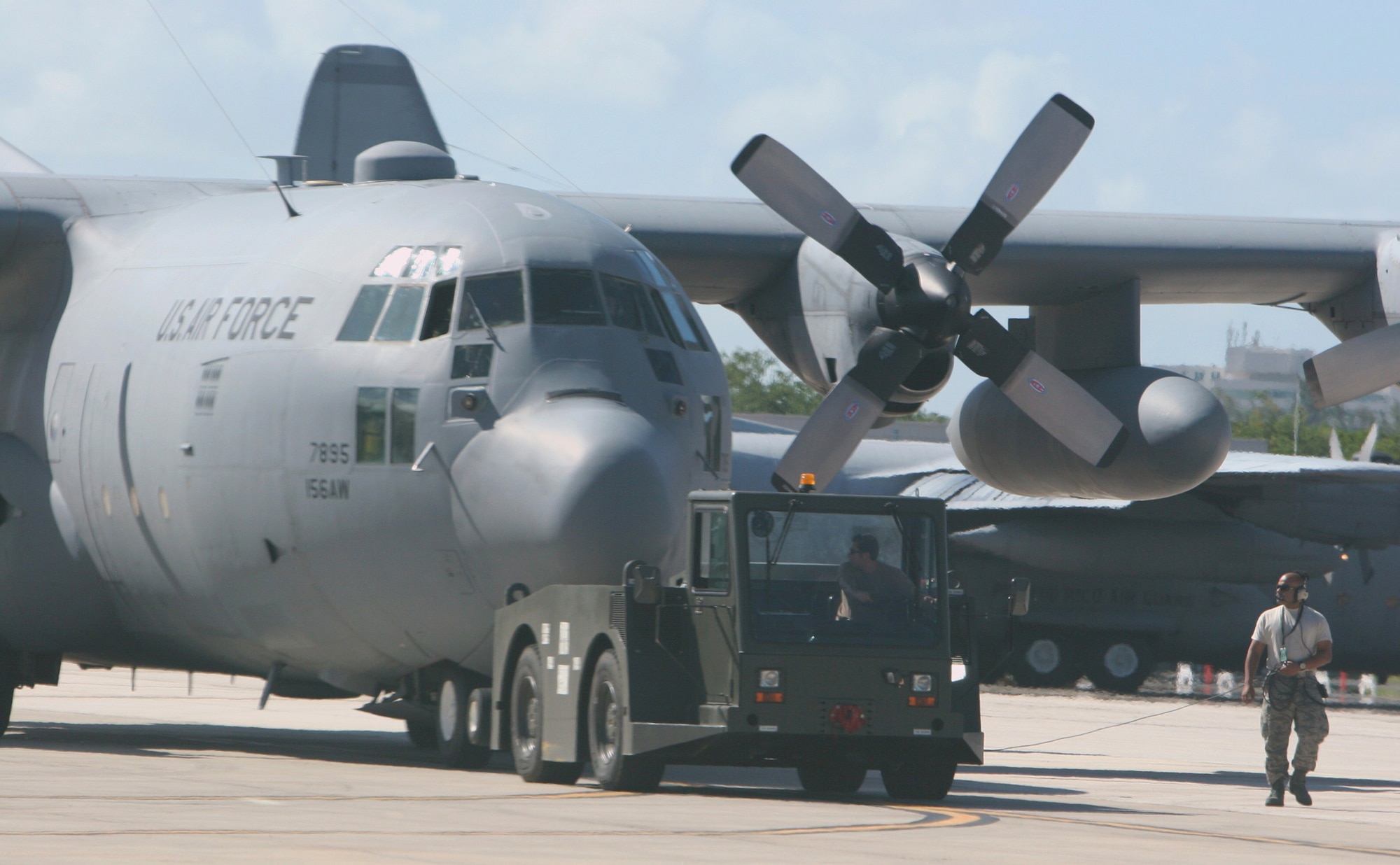 Members of the 302nd Maintenance Squadron tow a C-130 aircraft to its parking spot Dec. 12, 2008, where they later performed required inspections at Muniz Air National Guard Base in Puerto Rico. The Airmen were deployed in support of Operation Coronet Oak, a U.S. Southern Command-supported mission encompassing several missions, including the resupply of U.S. embassies, medical evacuation and support for U.S. troops in the region. (U.S. Air Force photo/Master Sgt. Heldwin Brito)
