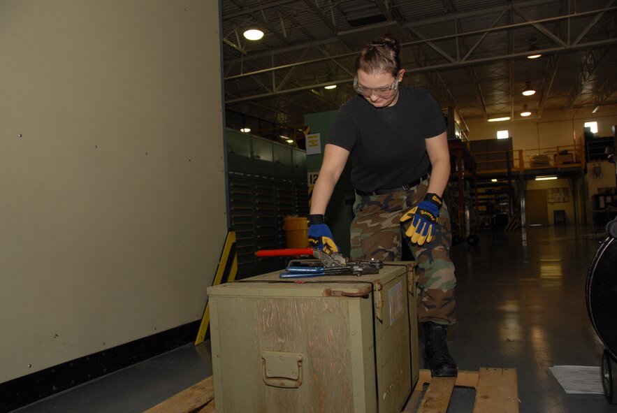 Senior Airman Patricia Wise, 185th Air Refueling Wing/Traffic Management Office, Sioux City, Iowa Finnishes securing a package to a pallet prior to shipping it.
Official Air force photo by: Master Sgt. Bill Wiseman (Released)