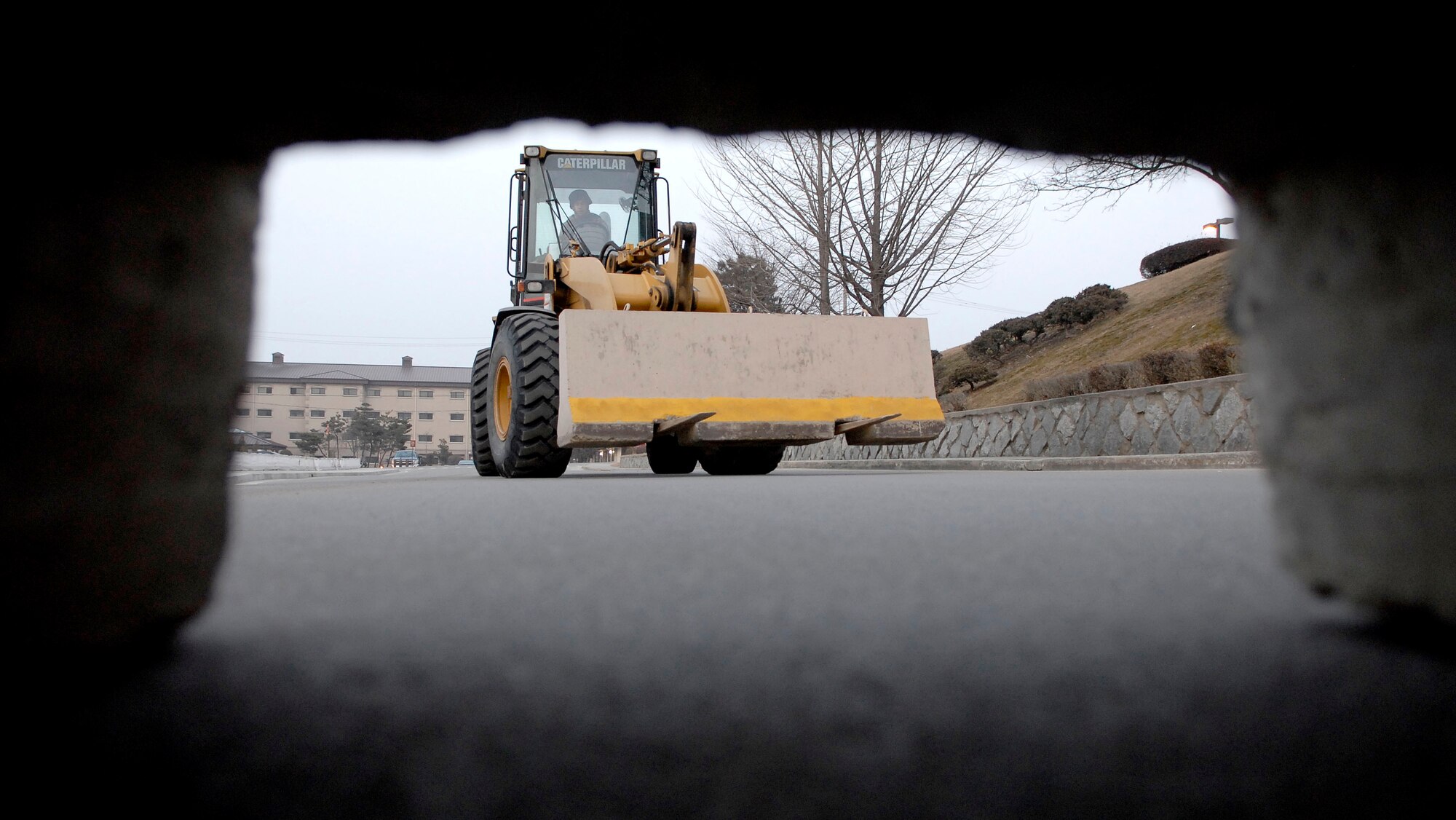 Senior Airman Nicholas Atencia uses a forklift to place road barriers around Osan AB in preparation for the 51st Fighter Wing’s Operational Readiness Exercise Beverly Midnight 09-01 at Osan AB, Republic of Korea, Feb. 8. The barriers are used to control traffic in and around sensitive areas. Airman Atencio is assigned to the 51st Civil Engineering Squadron.  (U.S. Air Force photo/Staff Sgt. Brian Ferguson)
 
