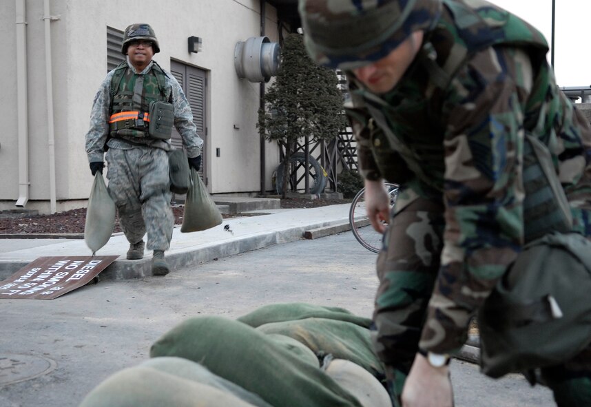 Airmen from the 51st Mission Support Squadron sandbag a fighting position in preparation for the 51st Fighter Wing’s Operational Readiness Exercise Beverly Midnight 09-01 at Osan AB, Republic of Korea, Feb. 8. Fighting positions provide all around cover from enemy fire and allows defenders to observe and repel enemy forces. (U.S. Air Force photo/Staff Sgt. Brian Ferguson)
 
