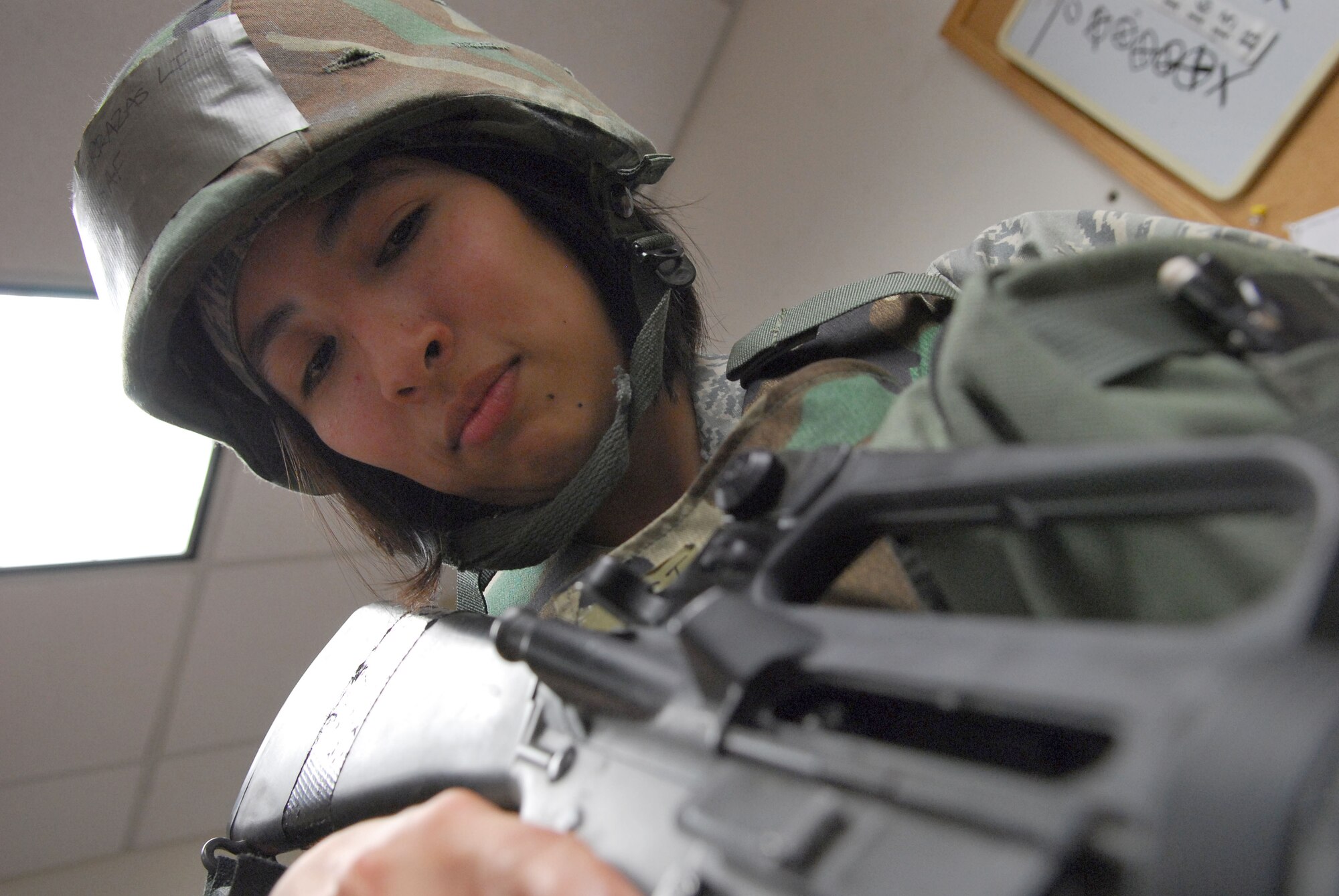 Staff Sgt. Liz Terrazas visually inspects the chamber of an M16A2 while performing weapons clearing procedures during the 51st Fighter Wing’s Operational Readiness Exercise Beverly Midnight 09-01 at Osan AB, Republic of Korea, Feb. 9. Sergeant Terrazas is a assigned to the 51st Mission Support Squadron.  (U.S. Air Force Photo/Senior Airman Christopher Boitz)
 
