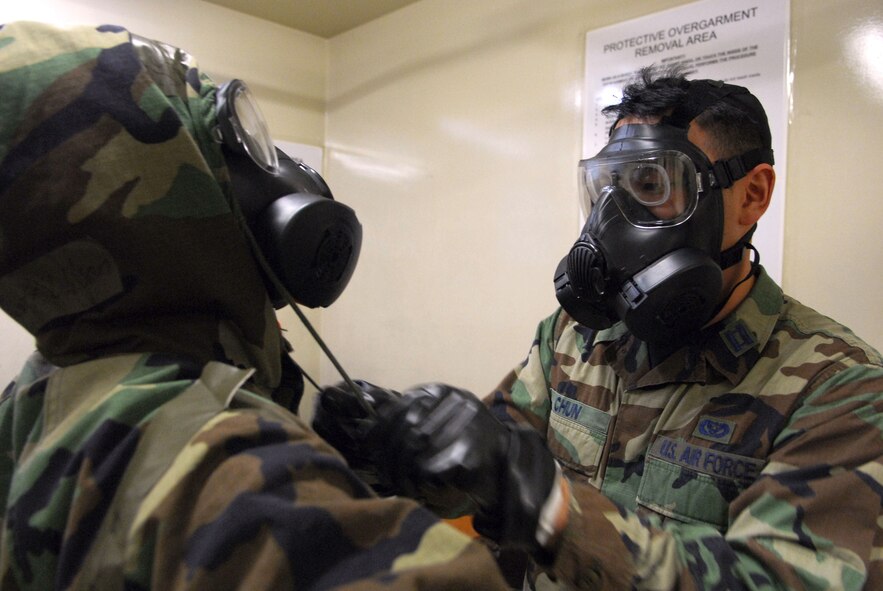Capt. Woosuk Chun removes his wingman’s protective over garment during the 51st Fighter Wing’s Operational Readiness Exercise Beverly Midnight 09-01 at Osan AB, Republic of Korea, Feb. 8. The exercise tests Team Osan's ability to survive and operate during a nuclear, biological, or chemical attack. Capt. Chun is assigned to the 51st Civil Engineer Squadron.  (U.S. Air Force Photo/Senior Airman Christopher Boitz)
 
