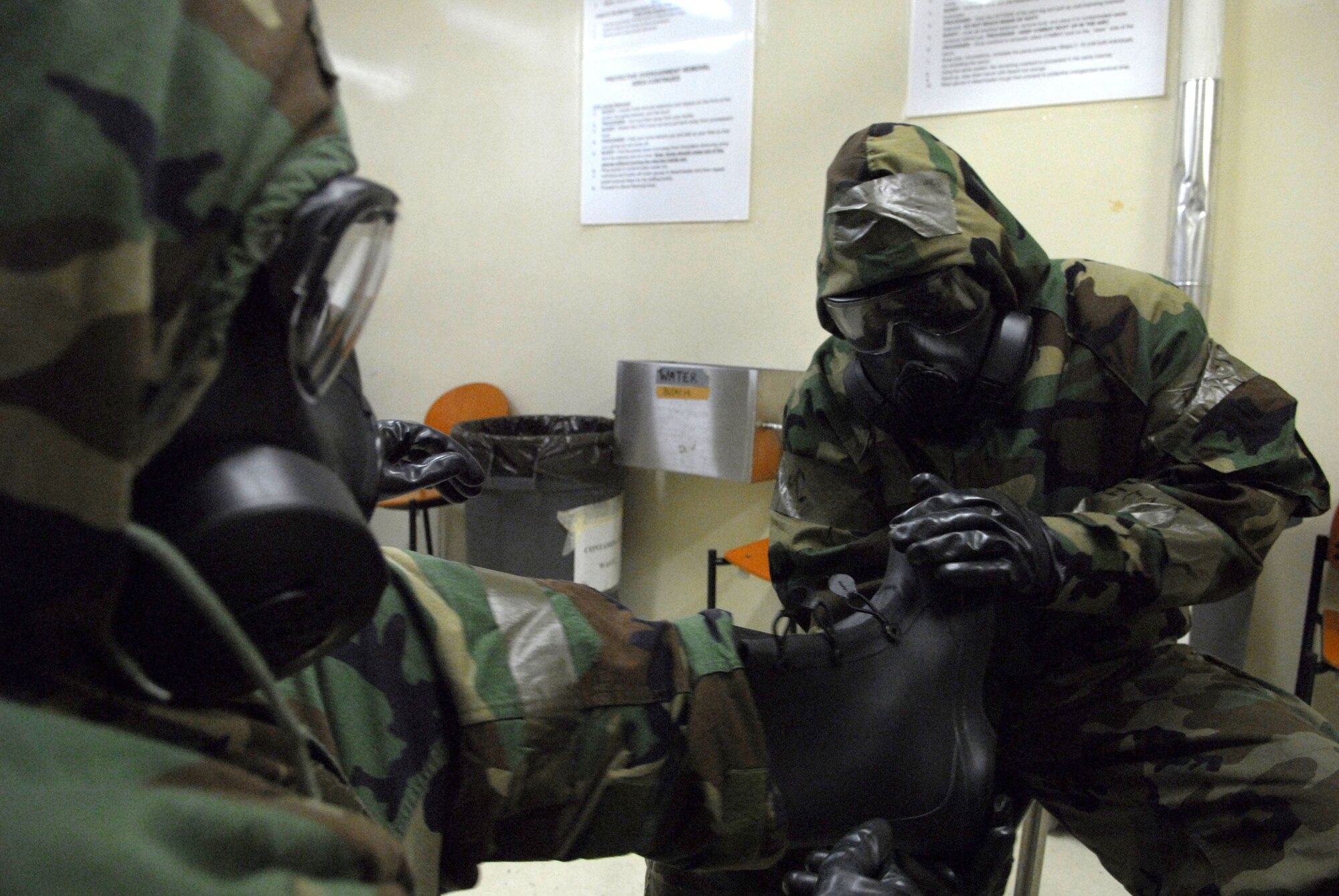 Airmen from the 51st Fighter Wing Emergency Operation center perform decontamination procedures during the 51 F W Operational Readiness Exercise Beverly Midnight 09-01 at Osan AB, Republic of Korea, Feb. 8. The exercise tests Team Osan's ability to survive and operate during a nuclear, biological, or chemical attack.  (U.S. Air Force Photo/Senior Airman Christopher Boitz)
 
