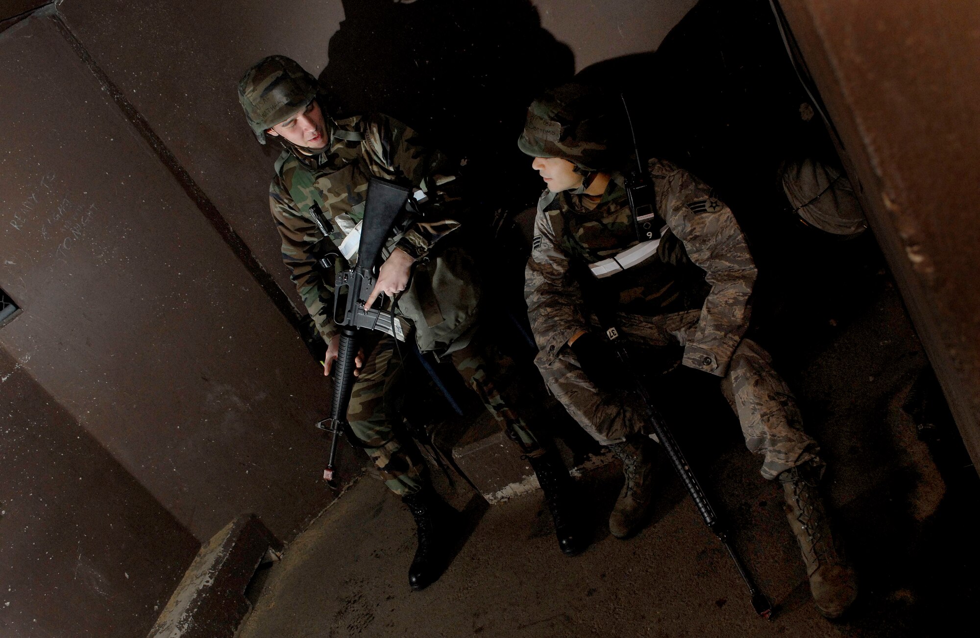 Airman 1st Class Nathan Witt, (left) and Senior Airman Travis Bottoms perform entry controller duties outside the 51st Logistic Readiness Squadron during the 51st Fighter Wing’s Operational Readiness Exercise Beverly Midnight 09-01 at Osan AB, Republic of Korea, Feb. 8. Entry controllers provide an additional line of security by ensuring only authorized personnel and vehicles enter controlled or restricted areas.  Both Airmen Witt and Bottoms are assigned to the 51 LRS. (U.S. Air Force Photo/Senior Airman Christopher Boitz)
 
