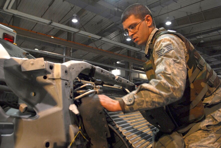Staff Sgt. John Von Elling disassembles the cooling system of an ambulance during the 51st Fighter Wing’s Operational Readiness Exercise Beverly Midnight 09-01 at Osan AB, Republic of Korea, Feb. 8. The cooling system had to be removed to fix a bent push rod that was stuck in the engine head. Sergeant Von Elling is a vehicle maintainer with the 51st Logistic Readiness Squadron.  (U.S. Air Force Photo/Senior Airman Christopher Boitz)