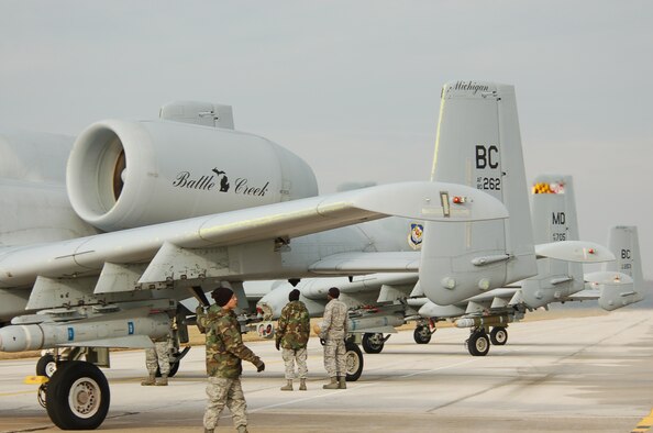 Airmen look over A-10s from Battle Creek, Mich. and Baltimore before launching them on a mission. Air Force photo by Tech. Sgt. David Speicher