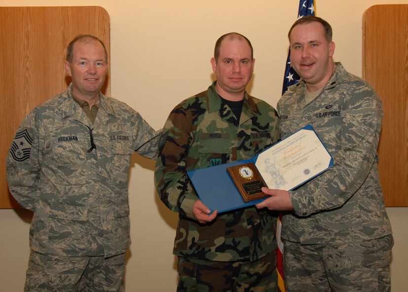 TSgt. Gasper A. Persio Jr, a Finance Specialist with the 174th Fighter Wing is presented the Air National Guard  Non-Commisioned Officer of the Year Award for 2008. Presenting the award is  the 174th Wing Command CMSgt David Heckman  and the 174th Firghter Wing Comptroller Lt. Col. Charles Hutson.