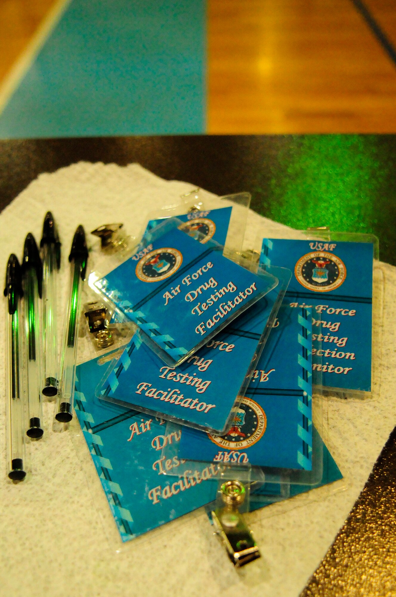 Drug Testing Facilitator identification badges line a table for distribution to volunteers participating in a sobriety checkpoint Feb. 7, 2009, at Ramstein Air Base. Sobriety checkpoints are held randomly throughout the Kaiserslautern Military Community in an effort to enforce a zero-tolerance policy against driving under the influence of drugs and alcohol. (U.S. Air Force photo by Staff Sgt. Stephen J. Otero) 