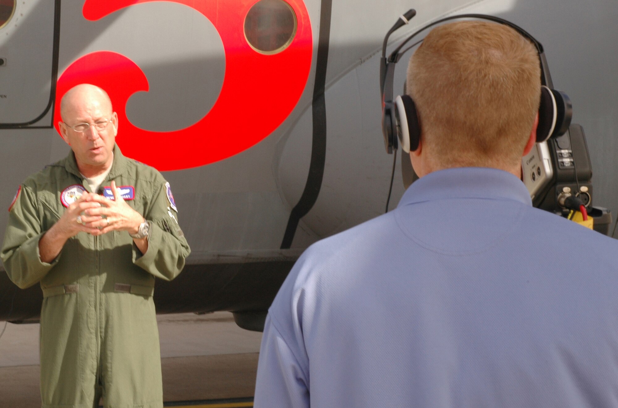 U.S. Air Force Gen. Gene Renuart, commander of U.S. Northern Command, produces a video Feb. 7, 2009, in front of a 302nd Airlift Wing-assigned C-130 at Peterson Air Force Base, Colo. The general provided a one minute, 30 second clip addressing the U.S. military's role in homeland defense via wildland firefighting missions. The video was expected to air at the Aerial Firefighting USA conference to be held Feb. 19-20 in Anaheim, Calif. The Air Force Reserve and Air National Guard both use Modular Airborne Firefighting Systems, known as 'MAFFS,' to fight wildfires if called upon to support state and local governments. For more information on MAFFS, visit www.302aw.afrc.af.mil. (U.S. Air Force photo/Senior Airman Stephen J. Collier)