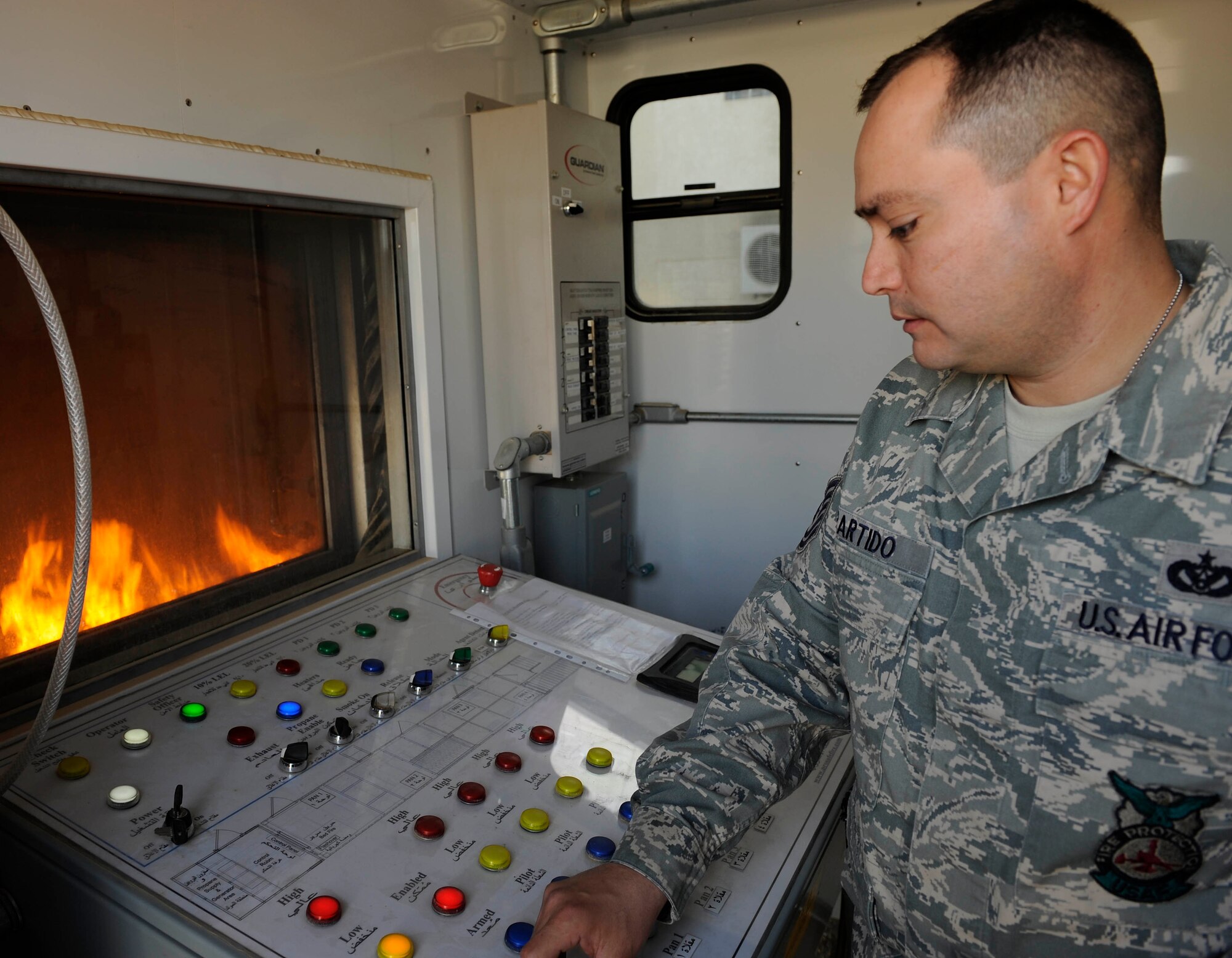 Technical Sgt. Brian Partido, 821st Basic Technical Training Squadron Coalition Air Force Training Team fire rescue advisor, starts the fire training simulator at the school house in Baghdad, Iraq Feb. 5.  Sergeant Partido is an Air Force advisor training the Iraqi air force and the Iraqi Civil Defense on basic firefighter. The Firefighters Managers Course is a 10-day class that covers general fire management, safety precaution, fire inspection, fire investigation and incident management system.  Sergeant Partido, a native of El Paso, Texas, is deployed from Little Rock Air Force Base. Ark. (U.S. Air Force photo by Senior Airman Jacqueline Romero)
