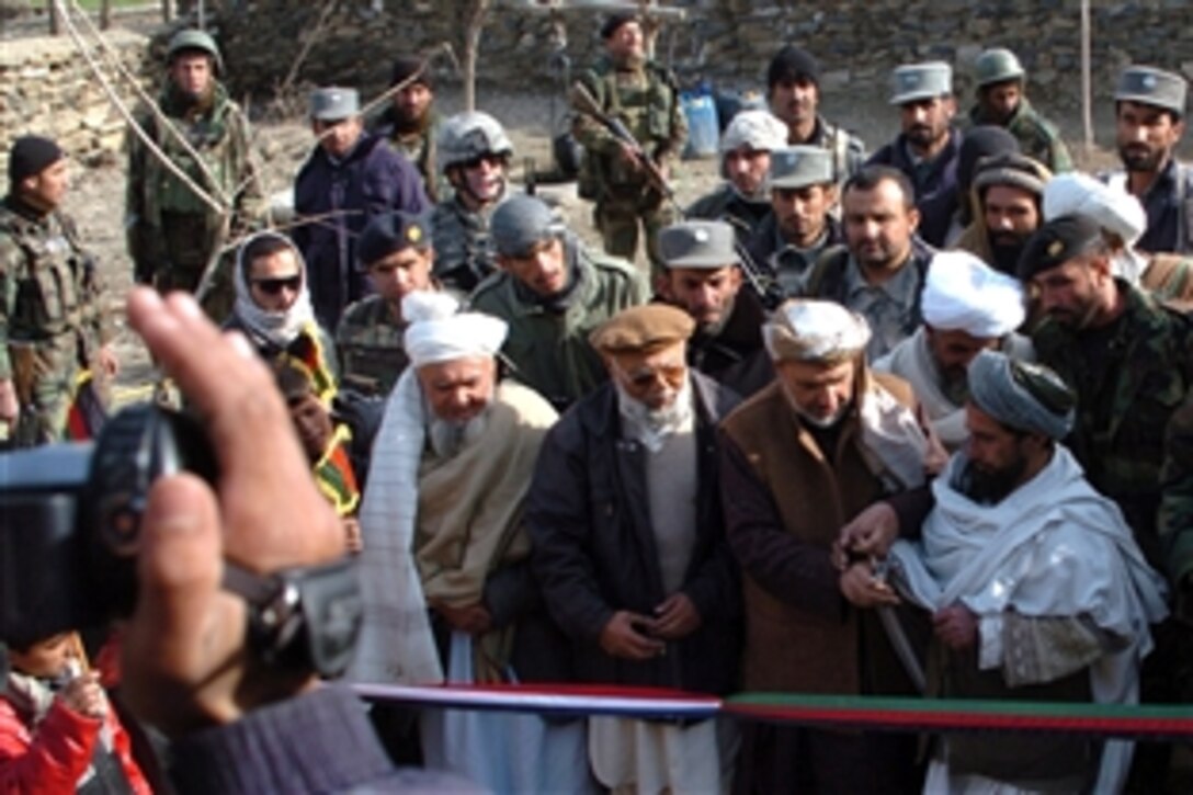 Afghans attend a ribbon-cutting ceremony in a village near Forward Operating Base Moralez Fraizer in Afghanistan, Feb. 7, 2009. 