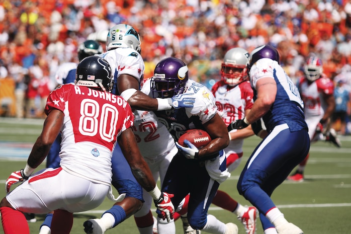 Minnesota Vikings' running back Adrian Peterson fights his way through the American Football Conference's defense to gain yards for a first down during the 2009 Pro Bowl at the Aloha Stadium Feb. 8. The National Football Conference left the game with a 30-21 win over the AFC.
