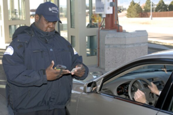Staff Sgt. William Powell scans a common access card Feb. 5, 2009, at Peterson Air Force Base's West Gate in Colorado. The CAC card is registered with the Defense Biometric Identification System, known as DBIDS, a new security tool being used at the base. To gain access to Peterson, all Department of Defense identification card holders are required to register with DBIDS. Peterson is the first stateside Air Force installation to implement the system. DBIDS is expected to be implemented at all government installations. (U.S. Air Force photo)