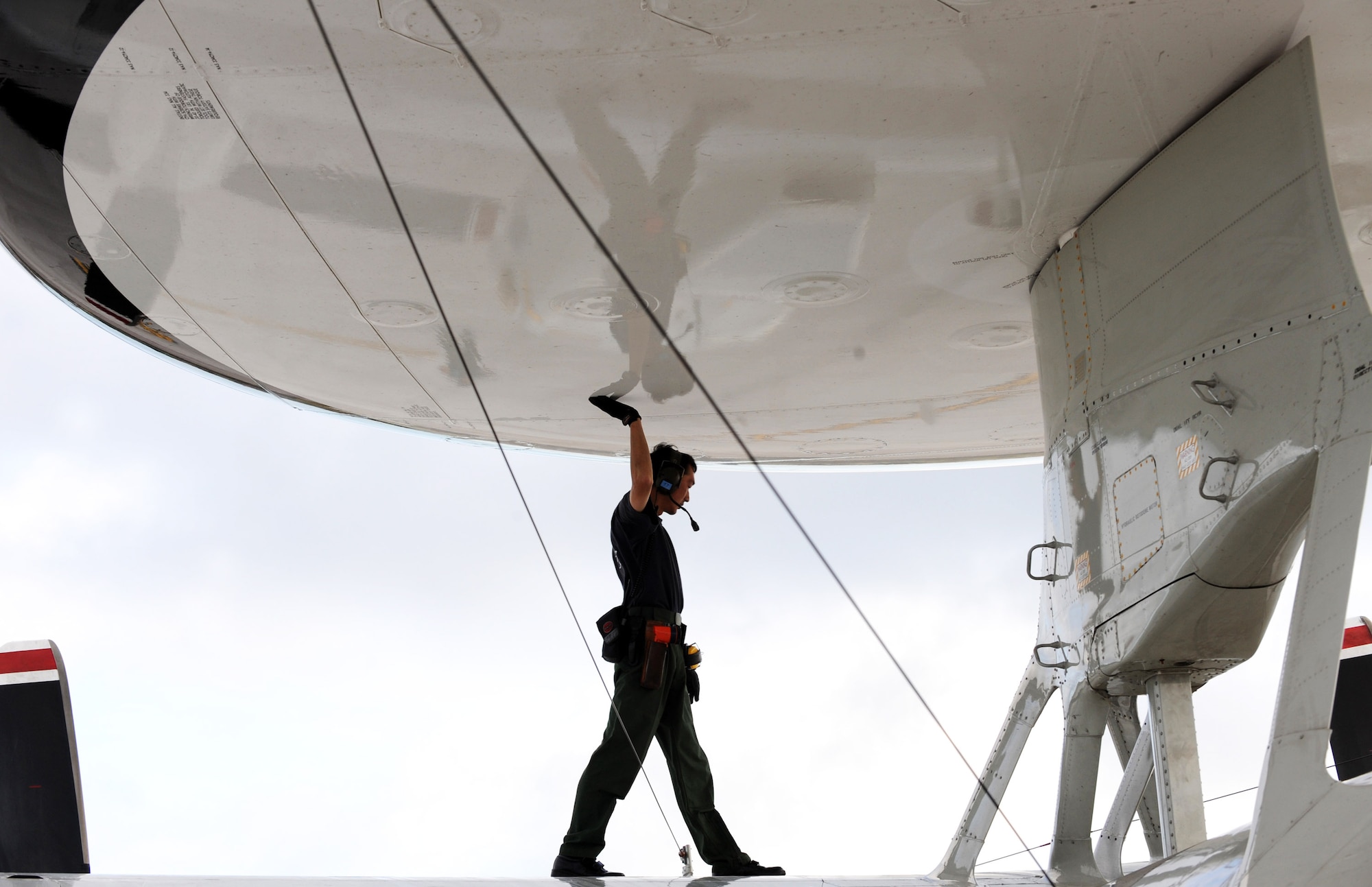 Sgt. Masatsugo Yamaguchi, a Japan Air Self Defense Force aircraft maintainer, inspects an E-2C Hawkeye Feb. 5 at Andersen Air Force Base, Guam, during Cope North 09-1 after a local-area mission. Units from the U.S. Air Force, U.S. Navy and the JASDF are participating in exercise Cope North 09-1 at Andersen from Feb 2 through 13. The exercise is the first iteration of a regularly scheduled joint and bilateral exercise and is part of the on-going series of exercises designed to enhance air operations in defense of Japan.  (U.S. Air Force photo/Master Sgt. Kevin J. Gruenwald) 