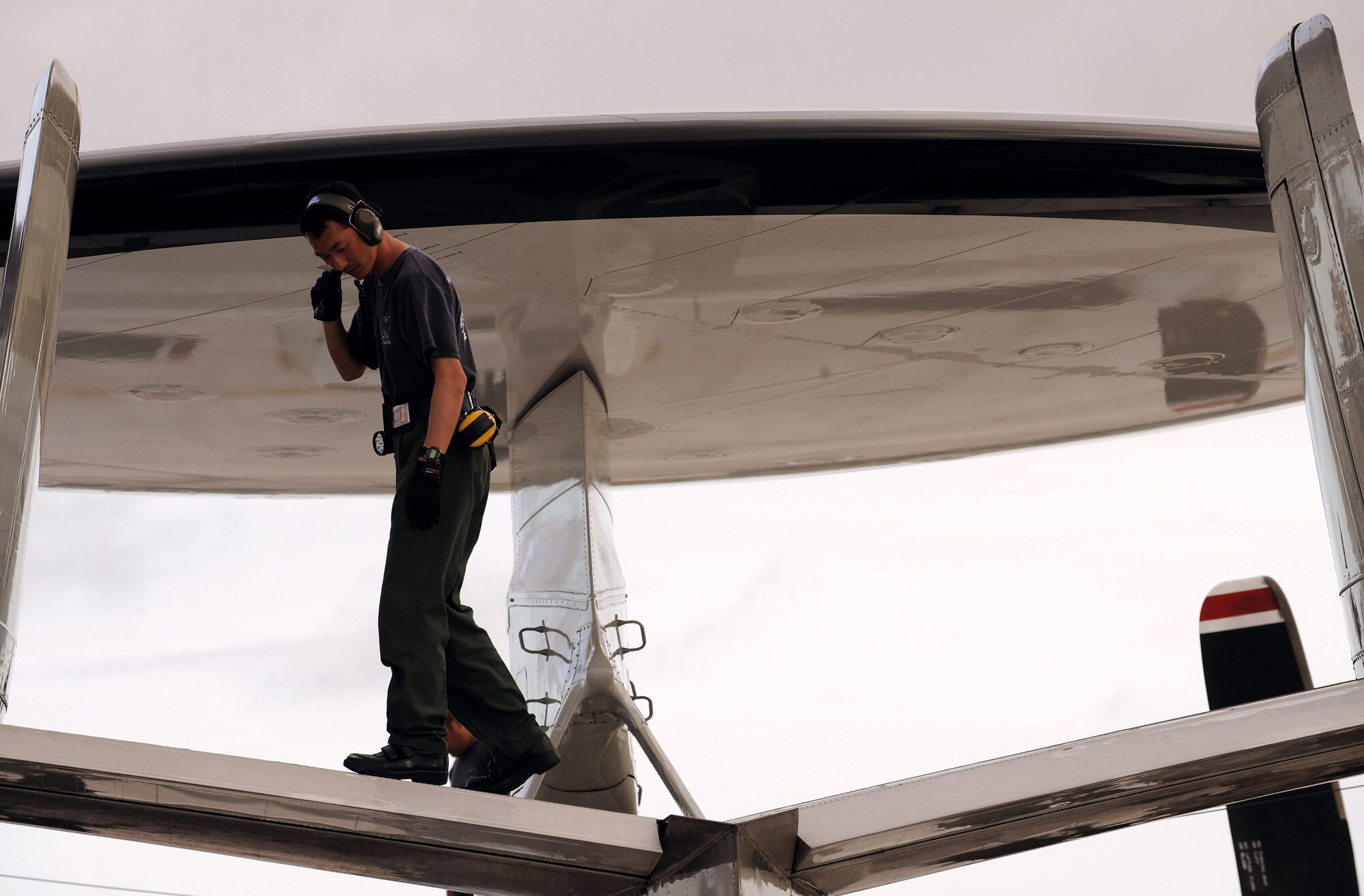 Sgt. Masatsugo Yamaguchi, a Japan Air Self Defense Force aircraft maintainer, inspects an E-2C Hawkeye Feb. 5 at Andersen Air Force Base, Guam, during Cope North 09-1 after a local-area mission. Units from the U.S. Air Force, U.S. Navy and the JASDF are participating in exercise Cope North 09-1 at Andersen from Feb 2 through 13. The exercise is the first iteration of a regularly scheduled joint and bilateral exercise and is part of the on-going series of exercises designed to enhance air operations in defense of Japan.  (U.S. Air Force photo/Master Sgt. Kevin J. Gruenwald) 