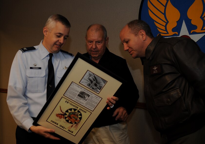 MOODY AIR FORCE BASE, Ga. -- Col. Kenneth Todorov, 23rd Wing commander, Jack Hild, who helped form the Lt. Gen. Claire Lee Chennault Foundation of Flying Tigers, and Col. Michael O’Dowd, 23rd Fighter Group commander, look at information on the back of a frame here Jan. 30. Mr. Hild donated Flying Tiger memorabilia to the 23rd Wing as he received a tour of the base. (U.S. Air Force photo by Senior Airman Gina Chiaverotti)
