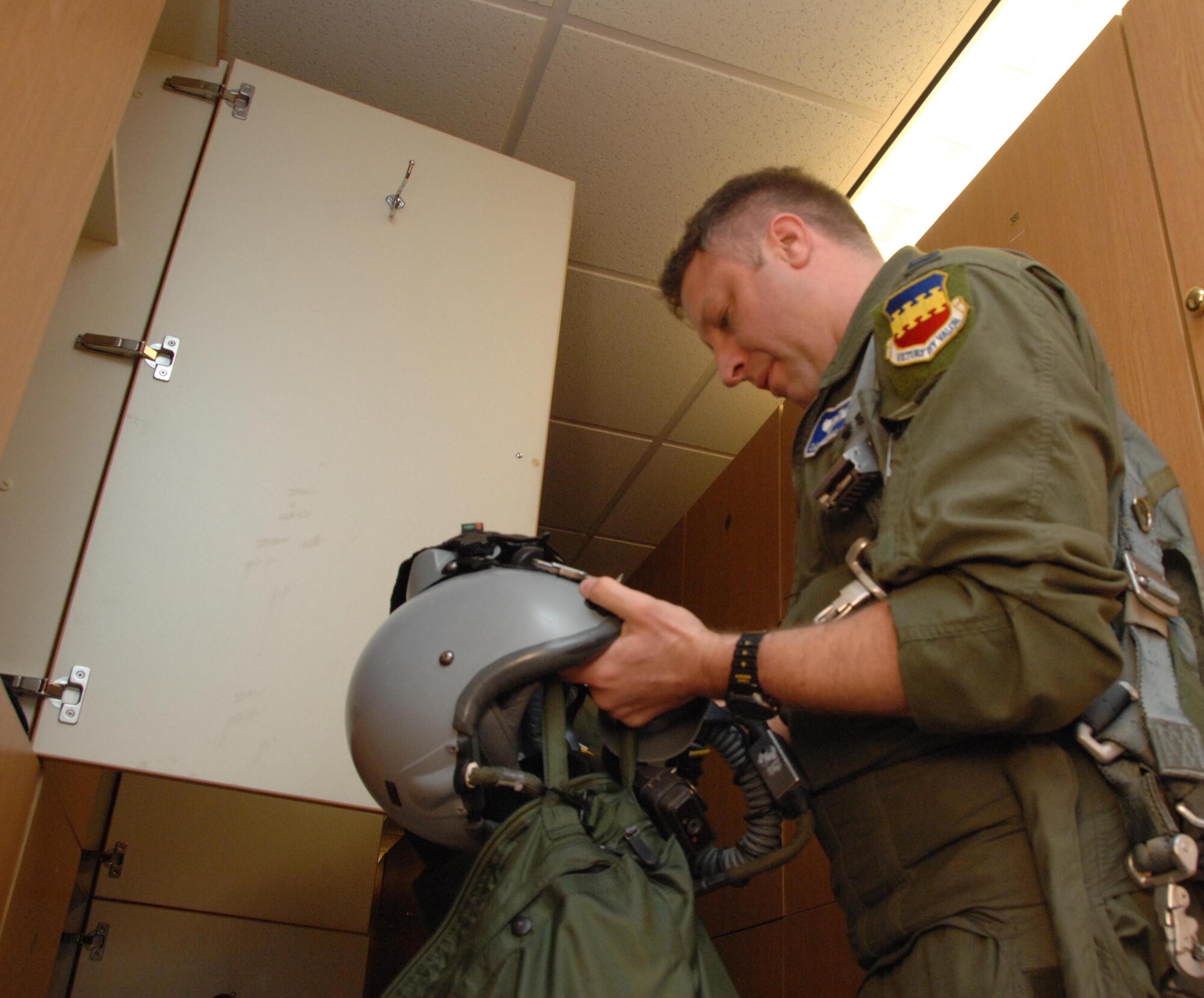 NELLIS AIR FORCE BASE, Nev. -- F-16 pilot Capt. Damien Ludwick, 55th Fighter Squadron, Shaw AFB, S.C., checks his helmet and flying gear before a sortie here Jan. 29 for RED FLAG 09-2. RED FLAG is a multinational exercise providing a realistic environment to practice combat, and has been proven to increase effectiveness and survival of pilots in wartime. (USAF Photo by 2nd Lt Noelle Caldwell) Released