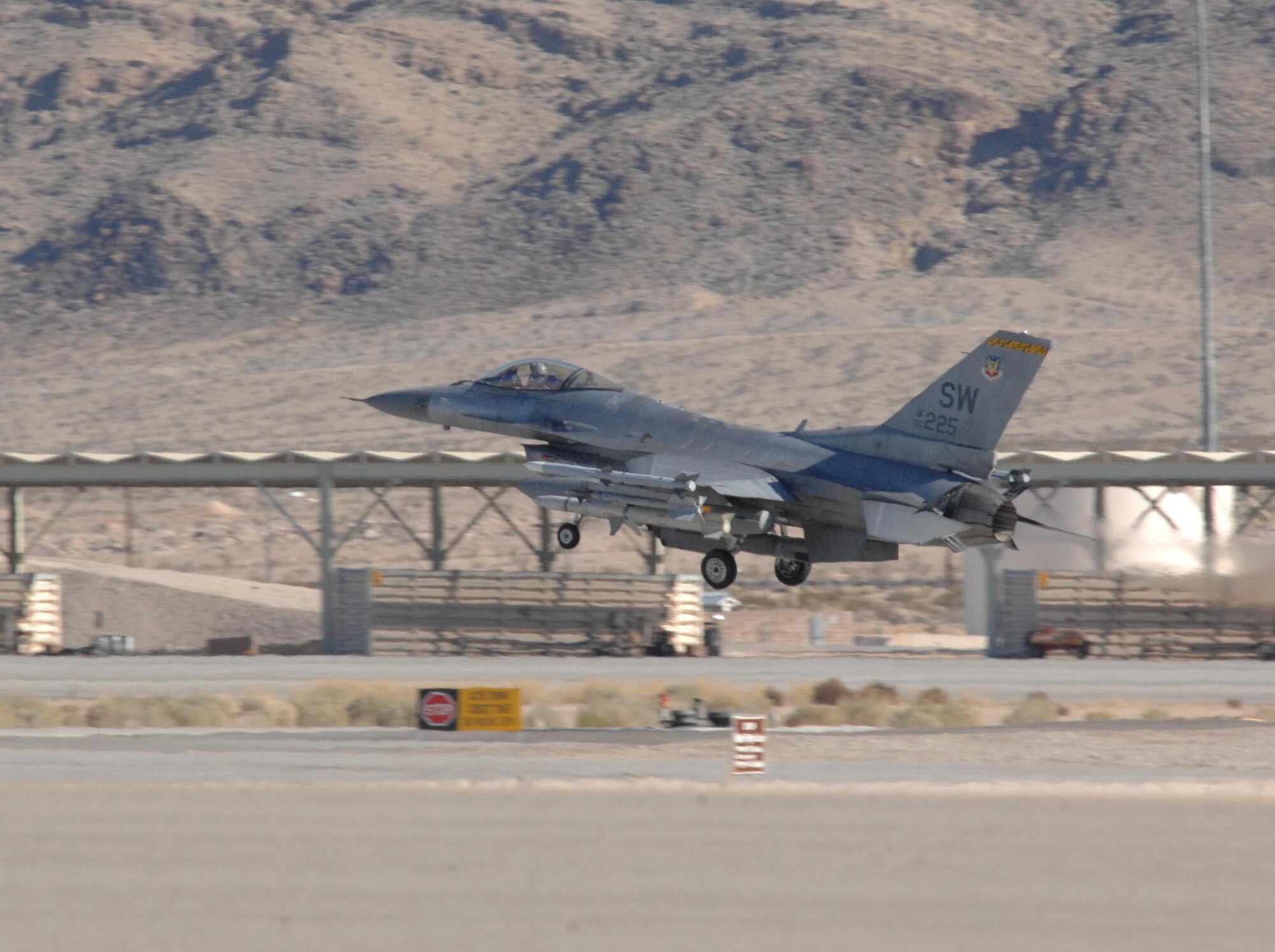 NELLIS AIR FORCE BASE, Nev. -- An F-16 pilot from the 79th Fighter Squadron, Shaw AFB, S.C., lands his jet here Jan. 28 after flying a mission for RED FLAG 09-2. RED FLAG is a multinational exercise providing a realistic environment to practice combat. The experience gained during the exercise is vital to pilots' survival. (USAF Photo by 2nd Lt Noelle Caldwell) Released