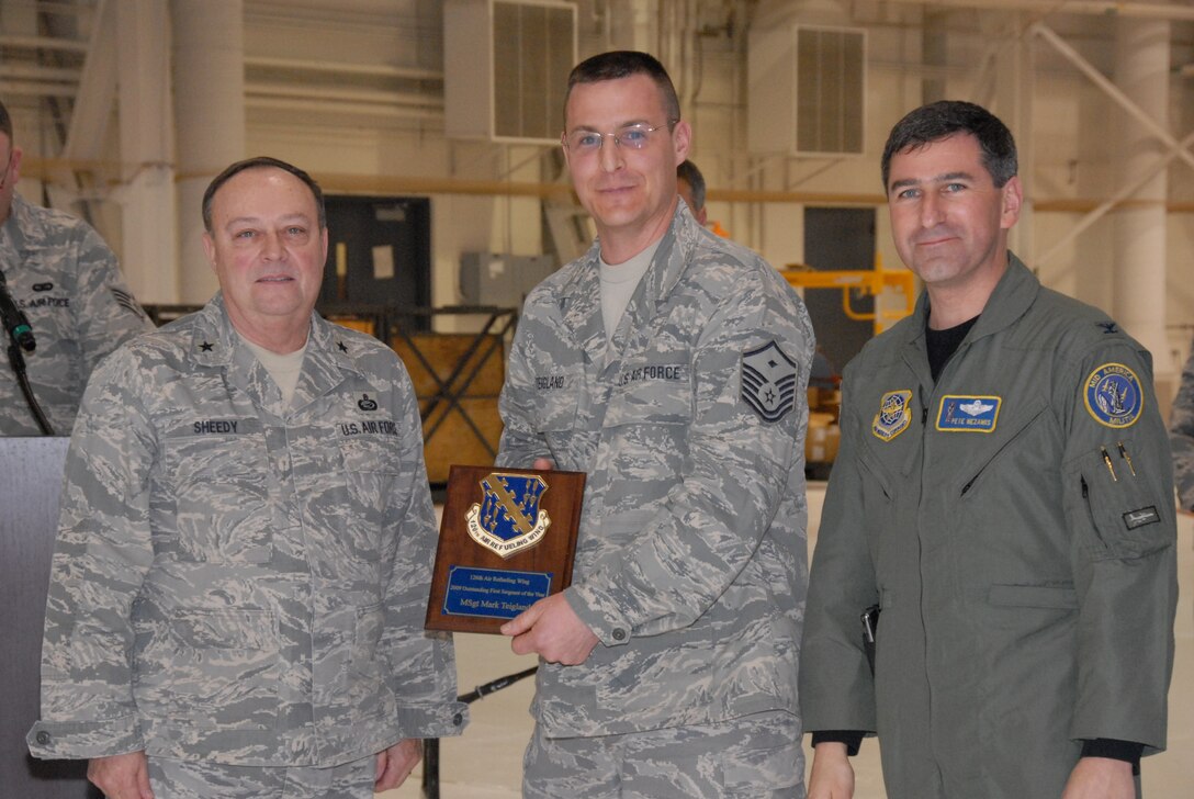 SCOTT AIR FORCE BASE, Ill. - Brig. Gen. John G. Sheedy, Assistant Adjutant General for Air and the Commander of the Illinois Air National Guard, and Col. Peter Nezamis, Commander of the 126th Air Refueling Wing, award Master Sgt. Mark Teigland, the 126th Medical Group First Seargent, the 2009 First Seargant of the Year for the 126 ARW. (U.S Air Force photo by Tech. Sgt. Mike Rice)