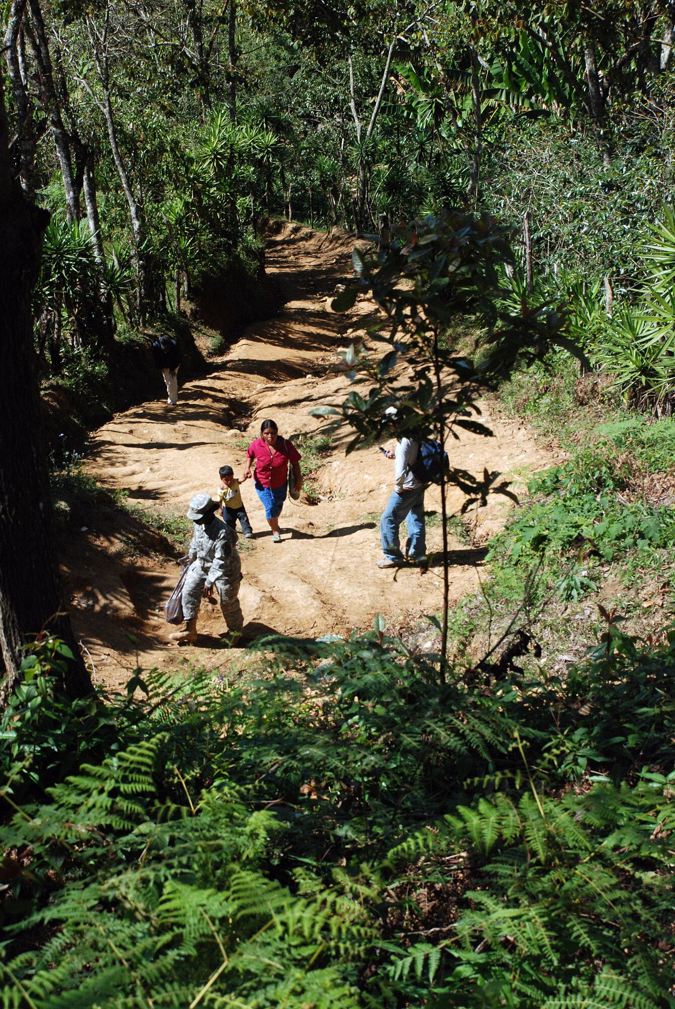 U.S. Army Sgt. Onika Hendricks, a member of a pediatric nutrition team, hikes back toward the rally point after visiting several homes in the remote village of Marcala, Honduras, to screen mothers and children for nutritional and dietary health. A team of 16 medical workers and dieticians traveled there from the United States to take part in a pediatric nutrition medical readiness training exercise.  The team partnered with specialists from the Honduran Ministry of Health and the medical element of Joint Task Force-Bravo, based at Soto Cano Air Base, Honduras. (U.S. Air Force photo/Tech. Sgt. Mike Hammond)
