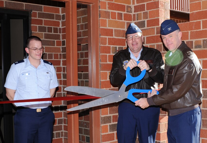 DYESS AIR FORCE BASE, Texas -- Colonel Robert Gass cuts the ribbon at the tax center here, Feb. 9.  The Dyess Tax center is ran by volunteers and allows Airmen and their families to file their taxes free of charge.  (U.S. Air Force photo by Staff Sgt. Alan Garrison)