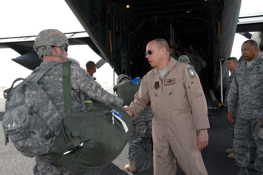 Gen. Donald Hoffman, Air Force Materiel Command commander, greets a Soldier boarding a C-130 Hercules Feb. 9 at an air base in Southwest Asia. General Hoffman visited the 386th Air Expeditionary Wing there as part of a multi-base visit in the area of operations. (U.S. Air Force photo/Senior Airman Courtney Richardson)
