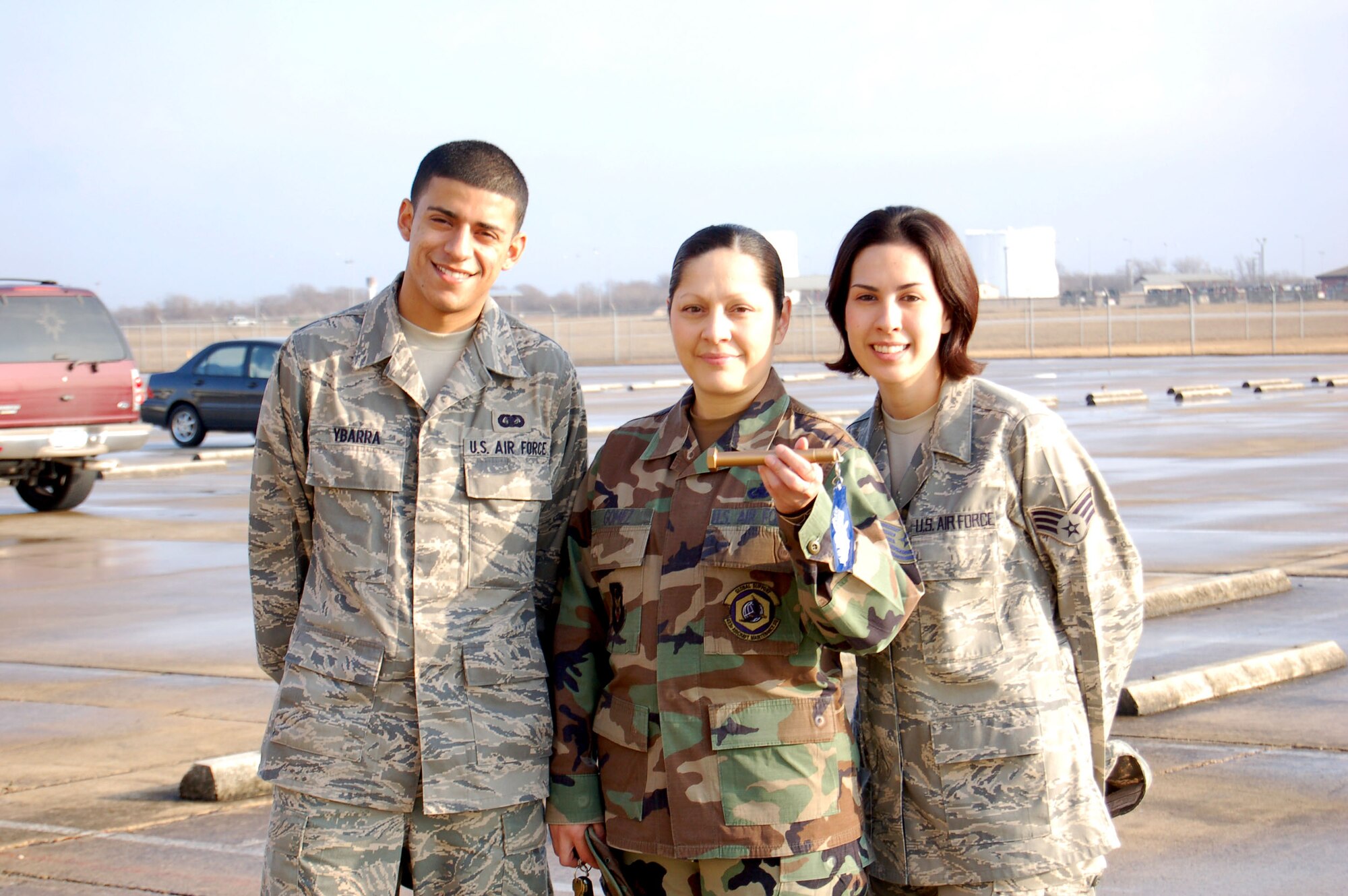 From left to right, Airman Basic John Ybarra from the 433rd Aircraft Maintenance Squadron, Tech. Sgt. Tina Gomez and Senior Airman Jessica Carrell from the 433rd Maintenance Group, were the first three to find El Dorado on the Alamo Wing flight line.  El Dorado, Spanish for "Golden One" was a legend from ancient South America of a chief who would cover himself in gold dust. The Alamo Wing has its own version of El Dorado, in the shape of a large, gold-painted bolt. The idea behind the golden bolt is to energize volunteers during the weekly Foreign Object Damage prevention walk by adding a little fun to the Monday morning clean-up event. The finder of El Dorado each week is recognized by wing leadership with a certificate of appreciation. 
Since begining the weekly FOD walk, maintainers report fewer instances of nicked fan blades caused by items being sucked into the engine. Though exact numbers are not yet available, even one less nicked fan blade saves valuable man-hours.(U.S. Air Force photo/Master Sgt. Collen McGee) 