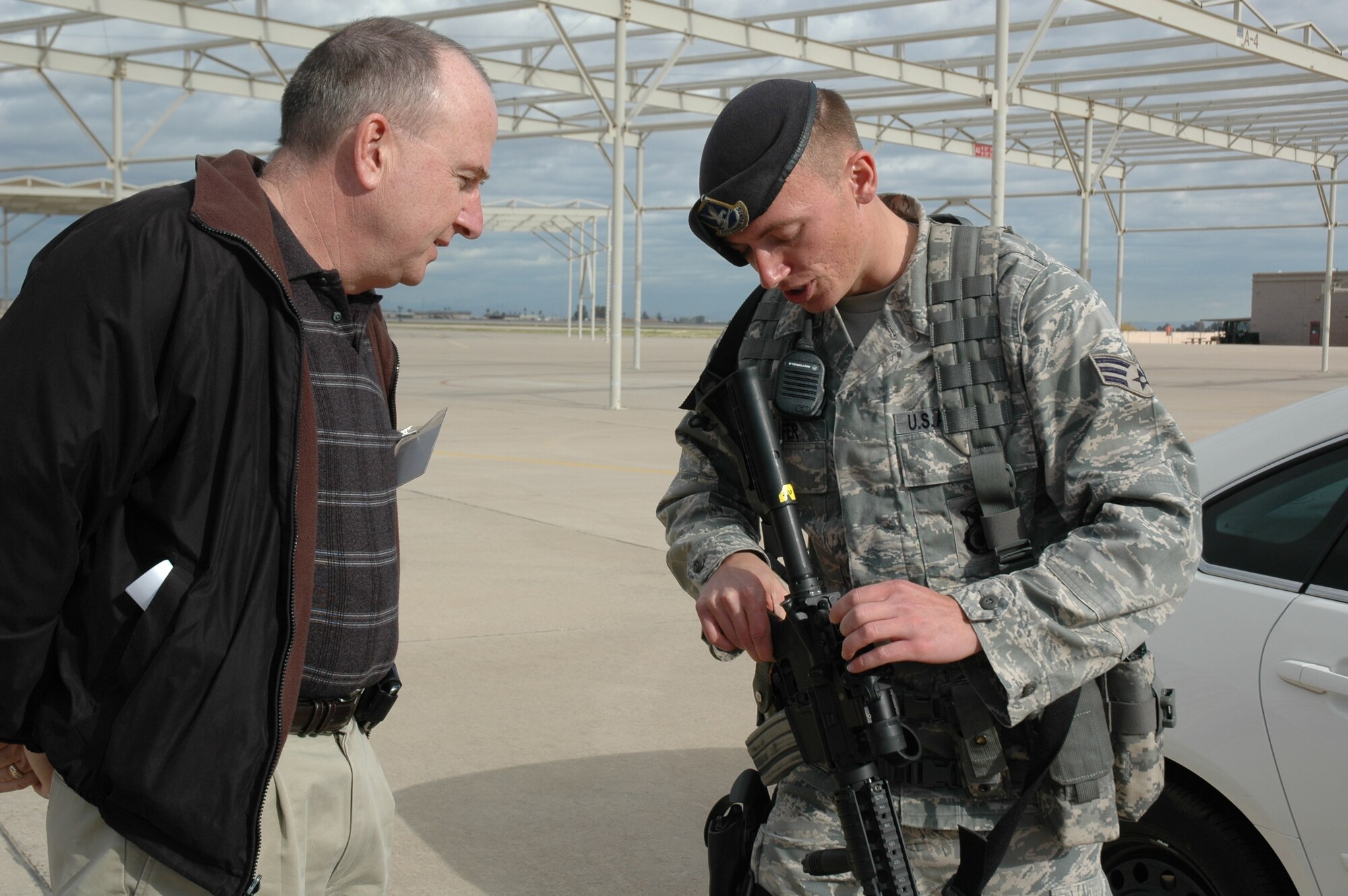 Benedict Carney, employee with the Department of Veterans Affairs in Phoenix, learns about the weapons systems and equipment used by security forces personnel during the 944th Fighter Wing's annual Bosses Day Feb. 7. (U.S. Air Force photo/Tech. Sgt. Susan Stout) 