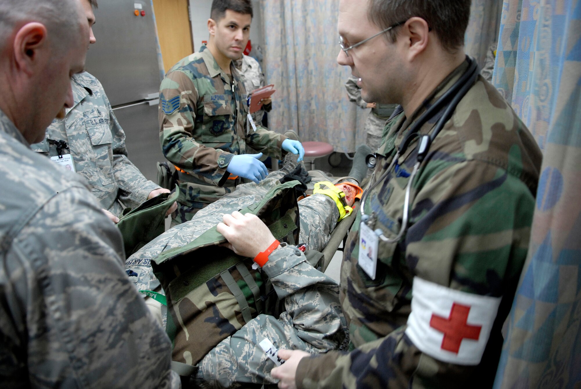 Airmen at the 51st Medical Group emergency room treat Col. Thomas Deale for a simulated broken leg,  during the 51 FW Operational Readiness Exercise Beverly Midnight 09-01 at Osan AB, Republic of Korea Feb 09. Colonel Deale is the 51st FW Commander. (US Air Force photo by Staff Sgt. Brian Ferguson)