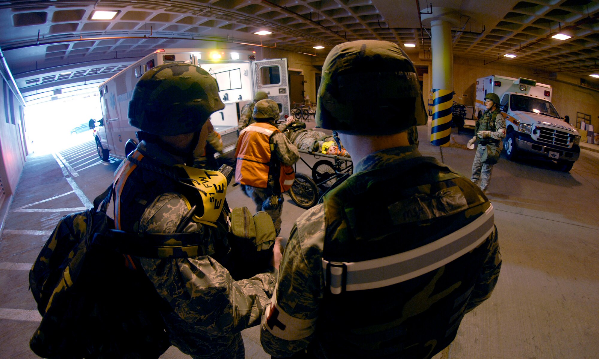51st Fighter Wing Exercise Evaluation Team members look on as Airmen from the  51st Medical Group unload Col. Thomas Deale at the base hospital to treat his simulated broken leg,  during the 51 FW Operational Readiness Exercise Beverly Midnight 09-01 at Osan AB, Republic of Korea Feb 09. Colonel Deale is the 51st FW Commander. (US Air Force photo by Staff Sgt. Brian Ferguson) 
