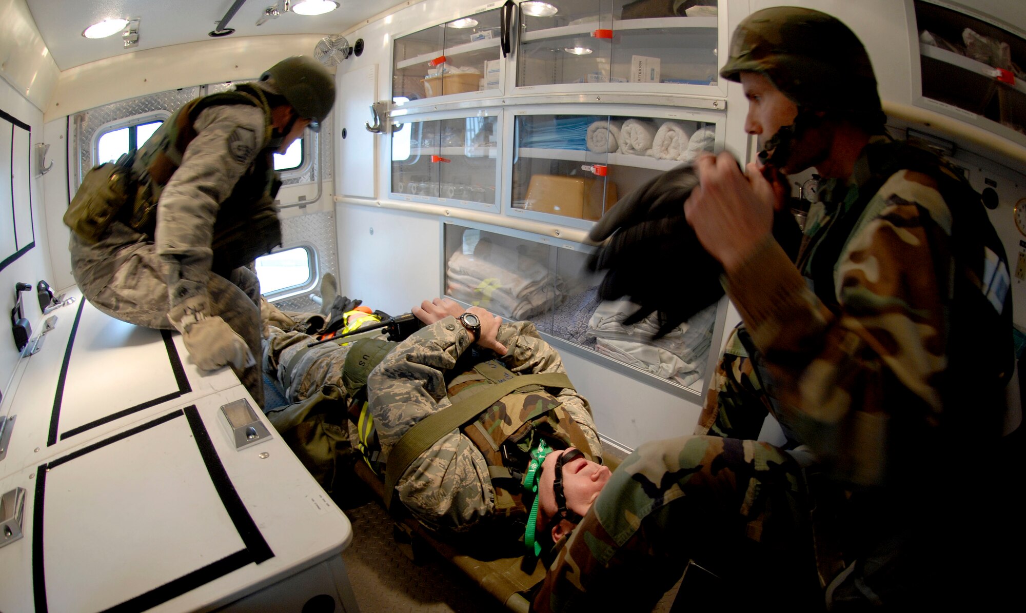 Airmen from the 51st Medical Group position Col. Thomas Deale in the ambulance before transporting him to the base hospital for a simulated broken leg sustained from performing a ?Bug out? of the Emergency Operations during the 51 FW Operational Readiness Exercise Beverly Midnight 09-01 at Osan AB, Republic of Korea Feb 09. . "Bug-out" drills are conducted to demonstrate the effectiveness of building occupants to evacuate quickly from a building as quickly and safely as possible. Colonel Deale is the 51st FW Commander. (US Air Force photo by Staff Sgt. Brian Ferguson) 