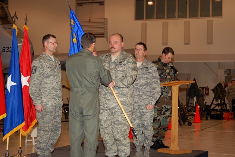 Lt Col Craig Logan receives the 124th Maintenance Squadron's flag from 124th Wing Commander Col James Compton upon assuming command of the 124th Maintenance Squadron after Col Robert Park took command of the 124th Maintenance Group. (Air Force photo by Staff Sgt Heather Walsh) (Released)