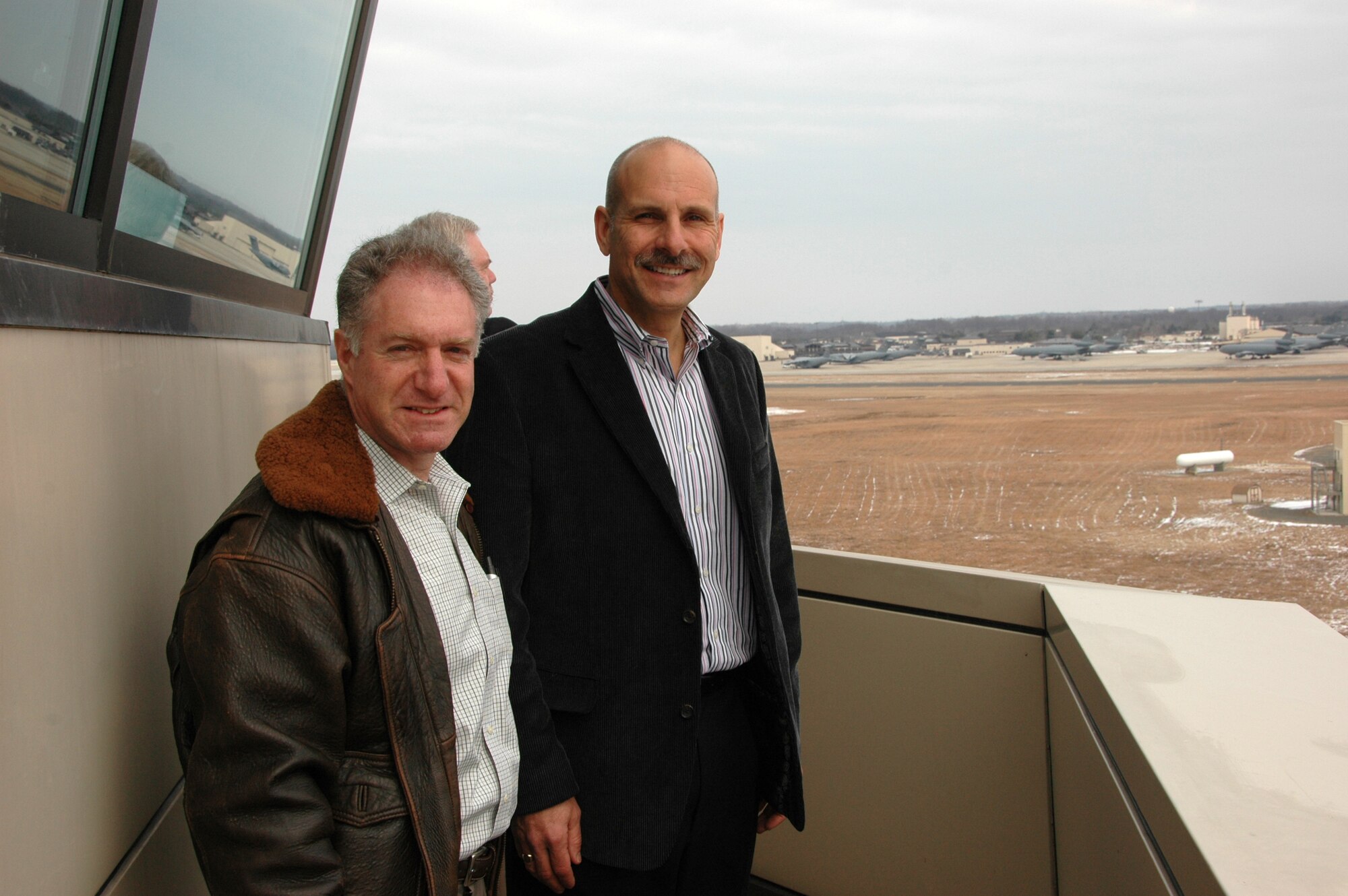 MCGUIRE AIR FORCE BASE, N.J. -- Lance Boxer, Vice Chairman of the USO (left) and Bill DeLorenzo (right) get a birds-eye view of the McGuire Air Force Base flightline from the control tower.  Mr. Boxer and Mr. DeLorenzo were part of a civic leader tour to McGuire, highlighted by visits to the control tower, KC-10 flight simulator and a static display of a C-17 aircraft. (U.S. Air Force photo/Master Sgt. Chuck Kramer)
