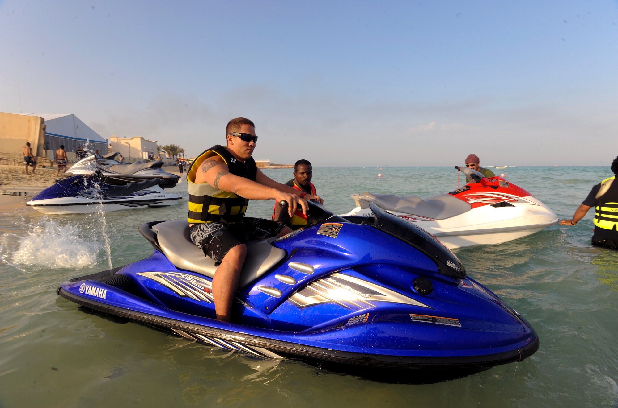 Petty Officer 2nd Class Christopher Kelly, United States Navy, prepares to ride a jet-ski during a cultural exchange event, Feb. 8, 2009, in an undisclosed location in Southwest Asia.  Jet-skis were one of many attractions for servicemembers who attended the event sponsored by the host nation.  AM2 Kelly, is originally from Hilo, Hawaii and is deployed from Kaneohe Naval Air Station in support of Operations Iraqi and Enduring Freedom and Combined Joint Task Force - Horn of Africa.  (U.S. Air Force Photo by Staff Sgt. Joshua Garcia/released)  