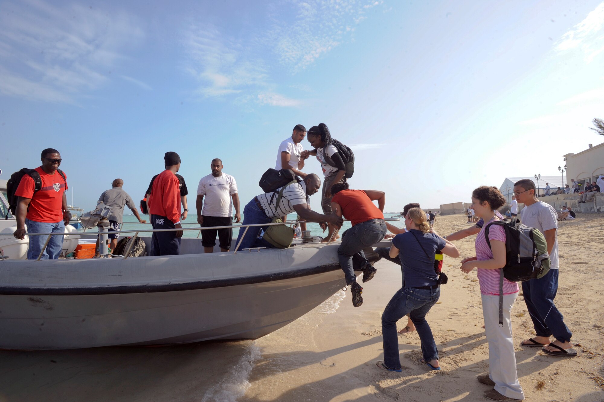 Servicemembers board a fishing boat during a cultural exchange event held Feb. 8, 2009, in an undisclosed location in Southwest Asia.  The event allowed servicemembers to experience the local culture and interact with host nation locals.  The night culminated with a feast of local delicacies.  (United Air Force Photo by Staff Sgt. Joshua Garcia/released)
