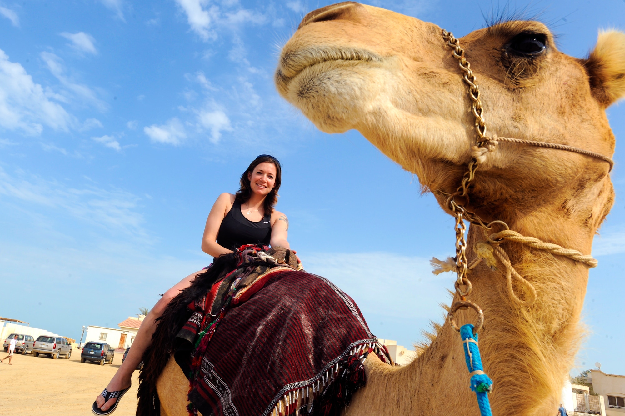 Senior Airman Katerina Slivinske, from the 379th Air Expeditionary Wing, enjoys a camel ride during a cultural exchange event put on by the host nation, Feb. 8, 2009, in an undisclosed location in Southwest Asia.  The event showcased local culture with camel rides as well as falconry demonstrations.  Airman Slivinske is originally from Ventura, Calif. and is deployed from Holloman Air Force Base, N.M. in support of Operations Iraqi and Enduring Freedom and Combined Joint Task Force - Horn of Africa.(U.S. Air Force Photo by Staff Sgt. Joshua Garcia/released)