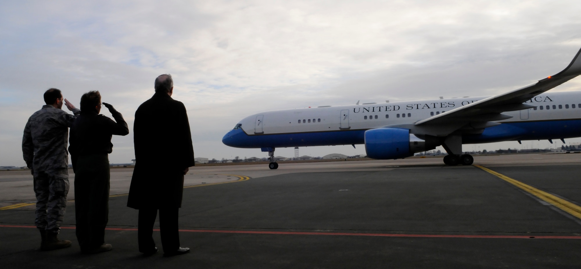 Col. Eden J. Murrie, 100th Air Refueling Wing commander, Command Chief Master Sgt. Antonio Hickey, and Richard LeBaron the Chargè  d'Affaires, A.I., salute as Vice President Joe Biden's plane prepares to depart following a two-hour visit to RAF Mildenhall, England, Feb. 8, 2009.  (U.S. Air Force photo by Senior Airman Christopher L. Ingersoll)