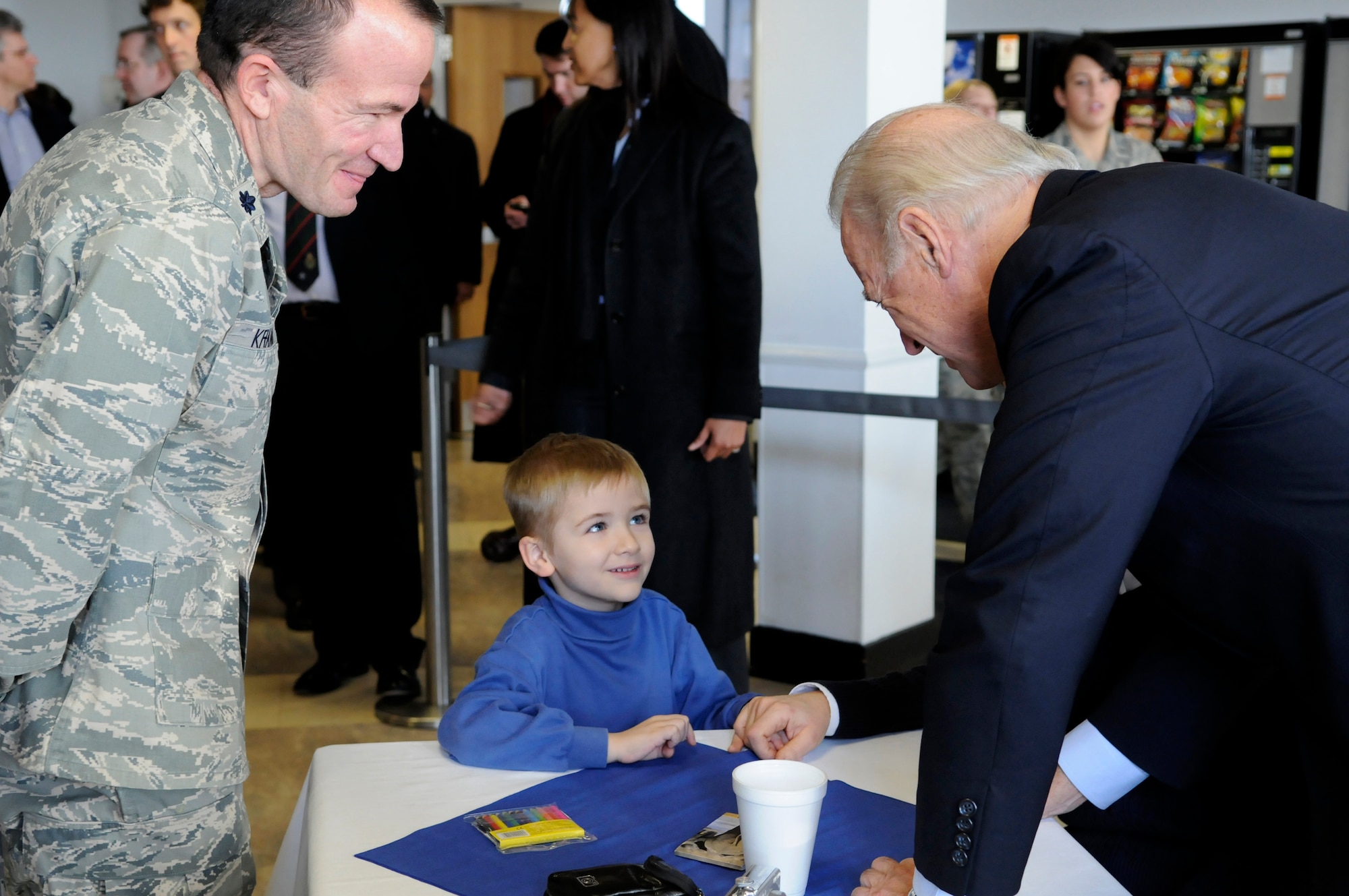 United States Vice President Joe Biden discusses coloring with Kevin Kramer, son of Lt. Col. Edward Kramer, 100th Air Refueling Wing Maintenance Group commander, during a two-hour visit to RAF Mildenhall, England, Feb. 8, 2009. (U.S. Air Force photo by Senior Airman Christopher L. Ingersoll)
