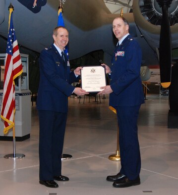 DOVER AIR FORCE BASE, Del. -- Former 512th Airlift Wing Vice Commander Col. David Wuest presents Chaplain (Lt. Col.) John Groth with his retirement certificate during a ceremony Feb. 7 at the Air Mobility Command Museum here. The Air Force Reserve chaplain held a farewell dinner at the AMC Museum Feb.6. During both events, colleagues of the Air Force Reserve chaplain shared memories and stories about his ministry and time spent in the Reserve. (U.S. Air Force photo/Staff Sgt. Steve Lewis)    