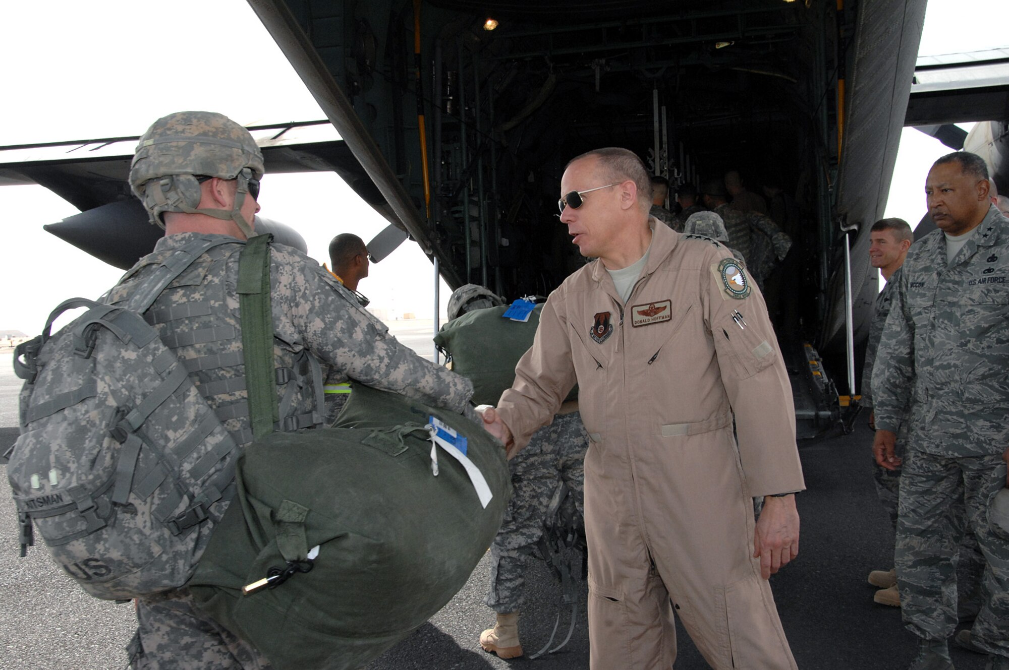 SOUTHWEST ASIA -- Gen. Donald Hoffman, Air Force Materiel Command commander, shakes hands with a Soldier boarding a C-130 heading to Iraq Feb. 9. General Hoffman visited the 386th Air Expeditionary Wing as part of a multi-base visit to the AOR. (U.S. Air Force photo by Senior Airman Courtney Richardson)