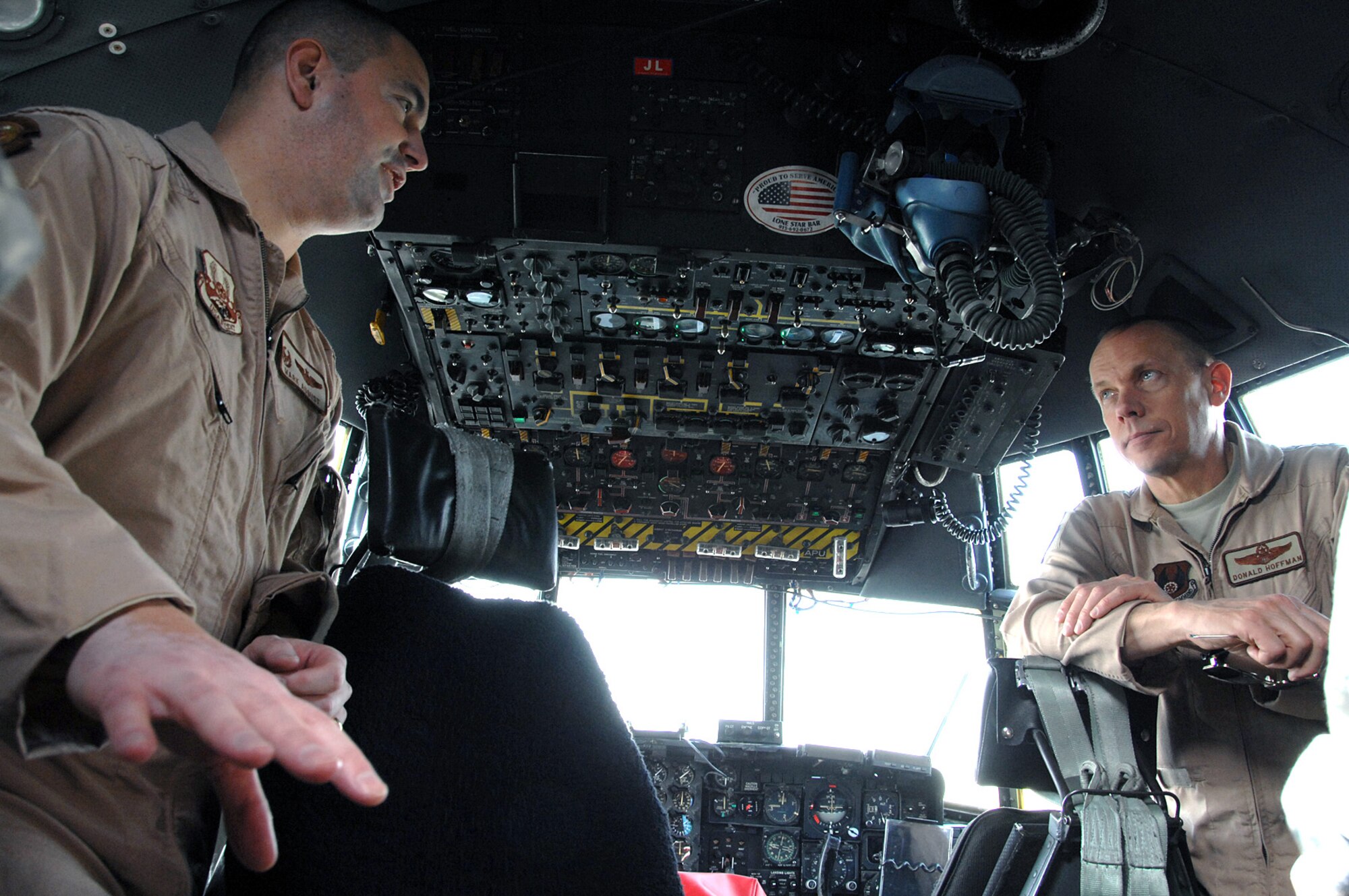 SOUTHWEST ASIA -- Lt. Col. Mark August, 737th Expeditionary Airlift Squadron commander, briefs Gen. Donald Hoffman, Air Force Materiel Command commander, in the cockpit of a C-130 during a flightline tour Feb. 9. General Hoffman visited the 386th Air Expeditionary Wing as part of a multi-base visit to the AOR. (U.S. Air Force photo by Senior Airman Courtney Richardson)