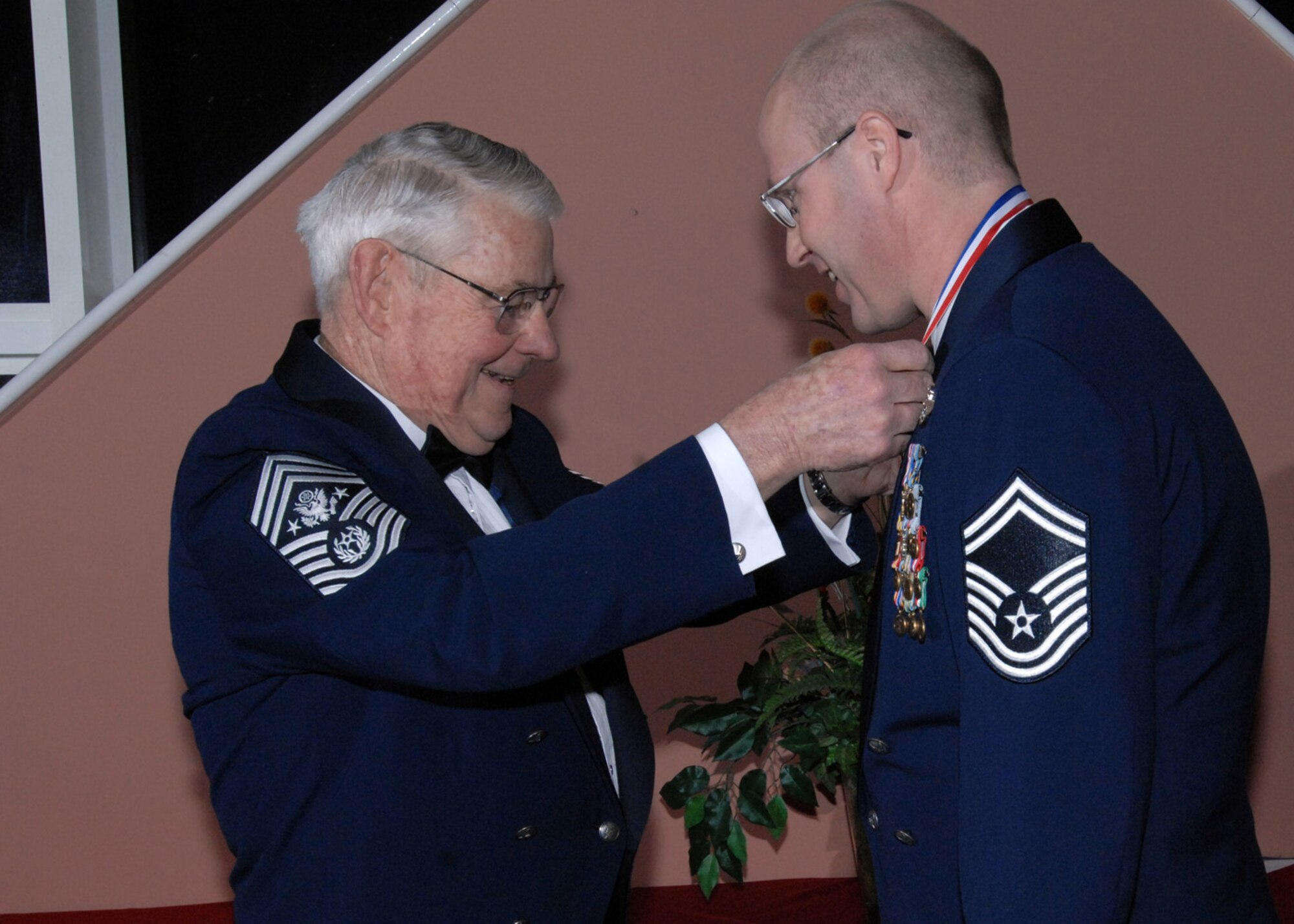 Retired Chief Master Sgt. of the Air Force Robert D. Gaylor places a medallion around the neck of chief select Todd Cole, 351st Air Refueling Squadron Superintendent, RAF Mildenhall before the Chief’s Recognition ceremony Feb. 7, 2009. The Chief’s Recognition ceremony was had at RAF Mildenhall in a joint effort with RAF Lakenheath and RAF Croughton to welcome the newest Chiefs throughout England into the highest enlisted rank. (U.S. Air Force photo by Senior Airman Teresa M. Hawkins)