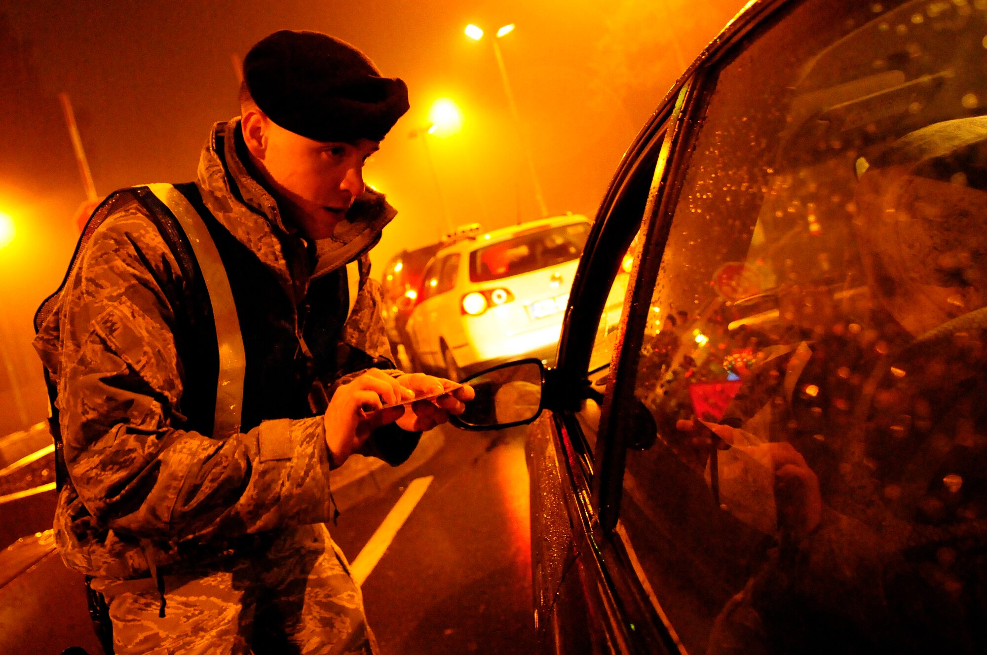Airman James Grueser, 435th Security Forces Squadron member, checks identification information while participating in a sobriety checkpoint Feb. 7, 2009, at Ramstein Air Base. Sobriety checkpoints are being held randomly throughout the Kaiserslautern Military Community in an effort to enforce a zero-tolerance policy against driving under the influence of drugs and alcohol. (U.S. Air Force photo by Staff Sgt. Stephen J. Otero) 