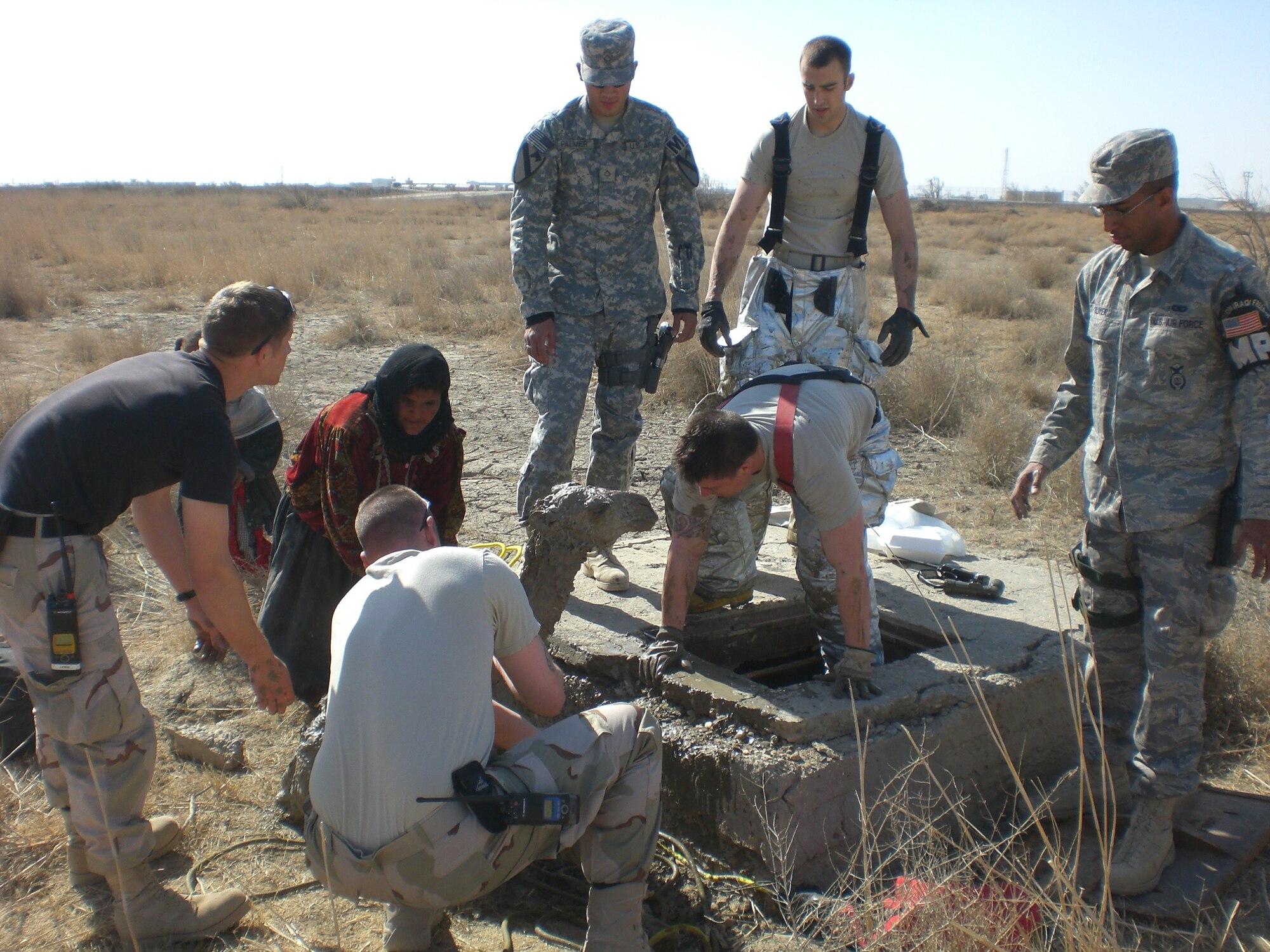 Firefighters assigned to the 407th Expeditionary Civil Enginner Squadron rescue a baby camel trapped in a manhole Feb. 2.