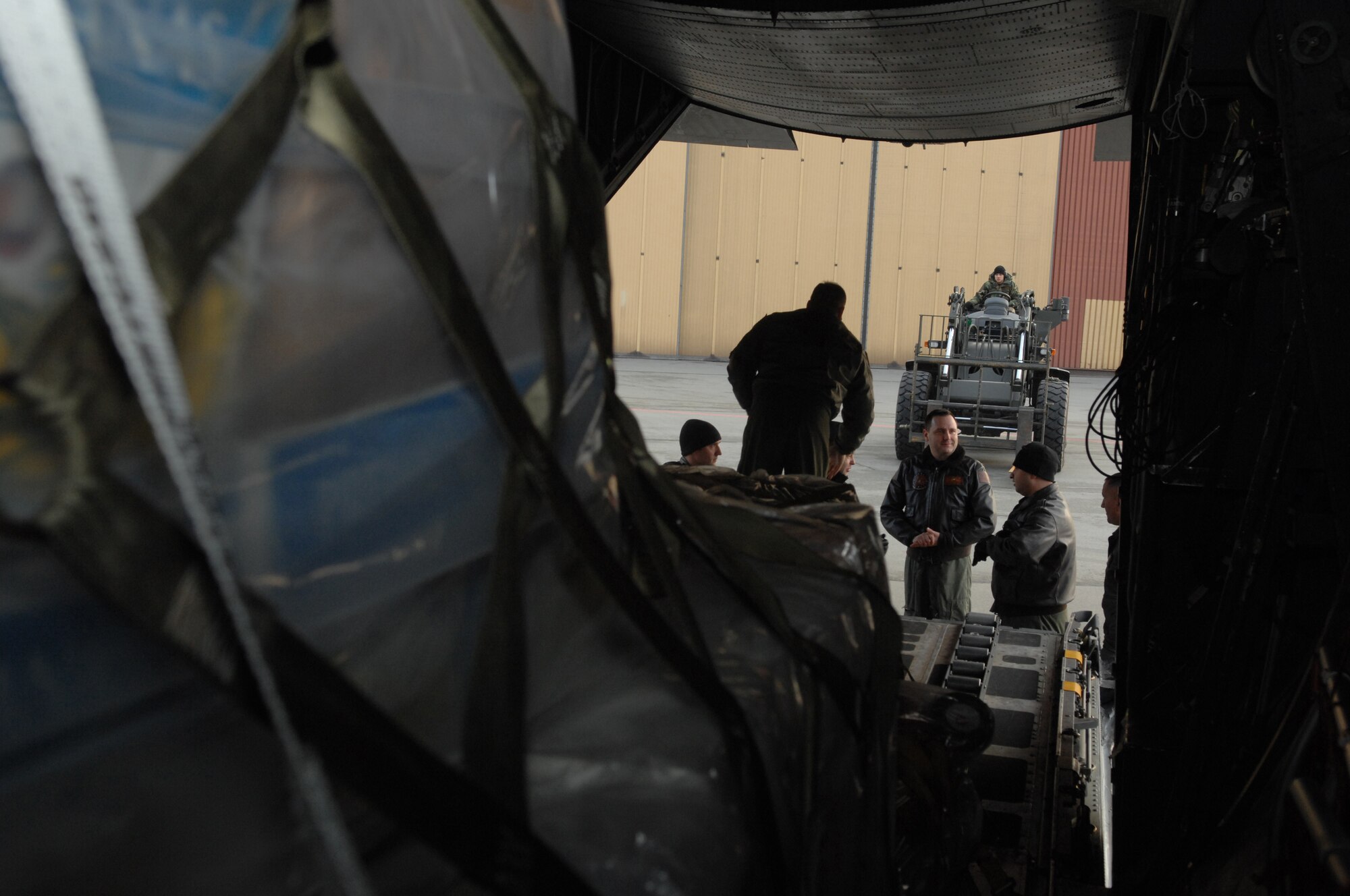 Members of the 86th Airlift Wing prepare to unload two pallets of toys to a truck bound for the My Home, My Future children's home Jan. 28, 2009, in Warsaw, Poland. The Kaiserslautern Military Community 5/6 Club donated 3,200 pounds of toys to the children?s home located in Slupsk. (U.S. Air Force photo by Senior Airman Amber Bressler)