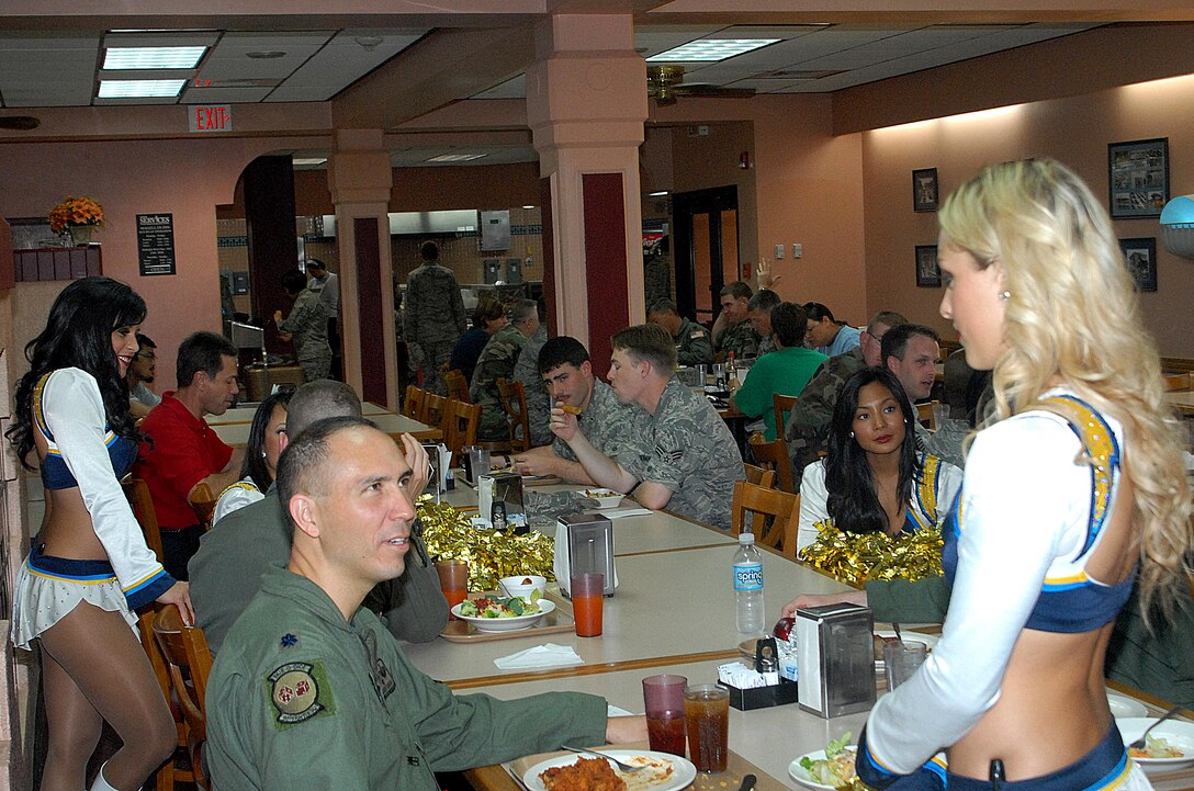 ANDERSEN AIR FORCE BASE, Guam -- Lt. Col. Orlando Sanchez, 90th Fighter Squadron commander, talks to a San Diego Charger Girl during the cheerleader's visit to Andersen's Magellan Inn Feb. 5. The cheerleaders also performed at the Top of the Rock ballroom. (Courtesy photo)