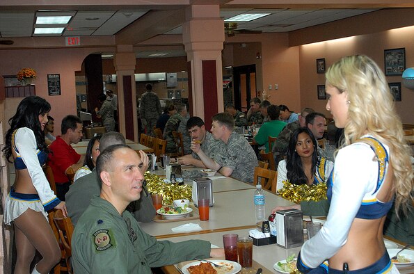 ANDERSEN AIR FORCE BASE, Guam -- Lt. Col. Orlando Sanchez, 90th Fighter Squadron commander, talks to a San Diego Charger Girl during the cheerleader's visit to Andersen's Magellan Inn Feb. 5. The cheerleaders also performed at the Top of the Rock ballroom. (Courtesy photo)