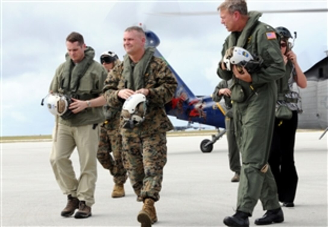 Commander of U.S. Naval Force Marianas Navy Rear Adm. William D. French, right, speaks with Vice Chairman of the Joint Chiefs of Staff U.S. Marine Gen. James E. Cartwright, center,  on the Andersen Air Force Base flight line following an island tour of Guam, Feb. 7, 2009. Cartwright visited Andersen to receive an operational update on the military forces based on Guam and the status of plans for moving Marines from Okinawa, Japan to Guam.