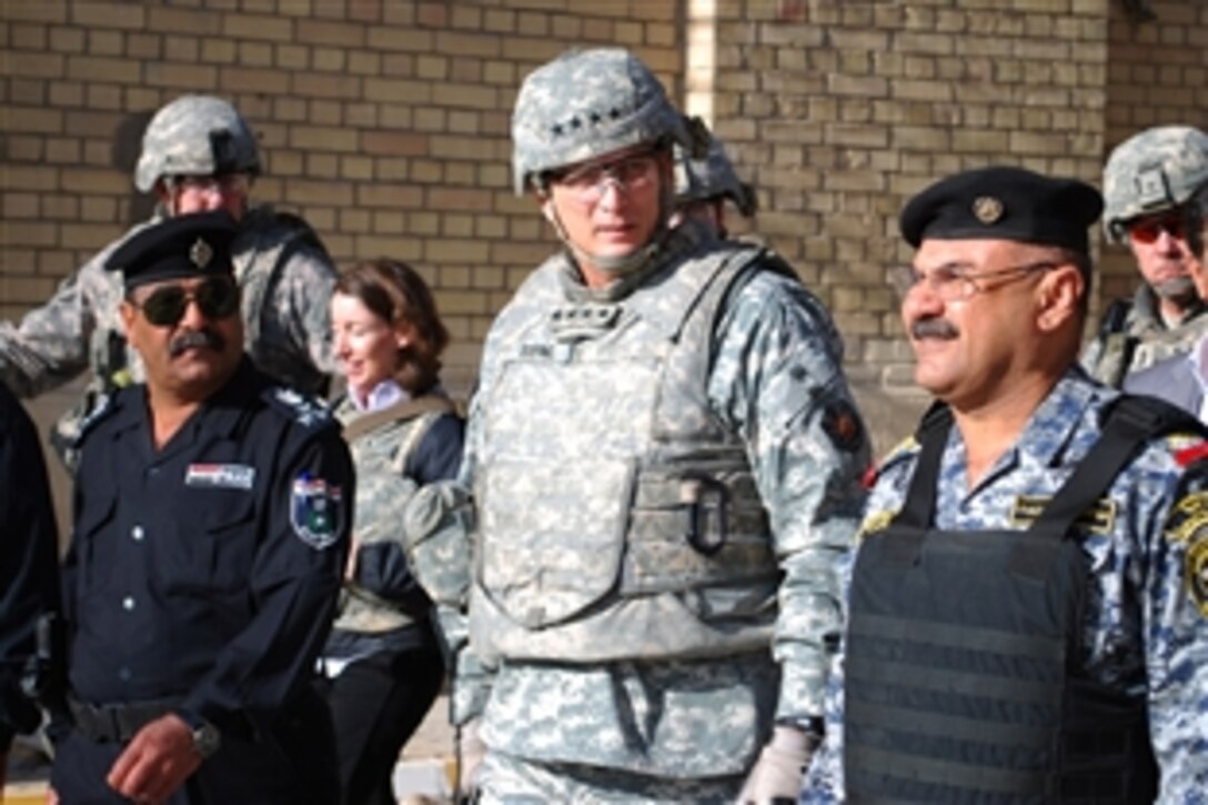 Iraqi Maj. Gen. Abdulkreem Abdulrahman Al-Izi, left, commander of the 1st National Police Division, leads U.S. Army Gen. Raymond T. Odierno, commander of Multinational Forces-Iraq, inside the Matanabi Book Market, Feb. 4, 2009, in the Rusafa District of eastern Baghdad. Two years ago, the market was closed due to a suicide bomber attack. Iraqi Prime Minister Nouri Al Maliki proclaimed the market as a symbol of strength and hope for the future of Iraq when the market reopened last December. 