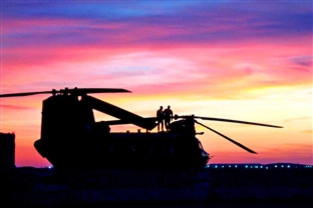 U.S. Army soldiers perform maintenance on a CH-47 Chinook helicopter parked on the flight line on Contingency Operating Base Speicher, Tikrit, Iraq, Feb. 4, 2009. The soldiers are assigned to the 25th Infantry Division's 3rd General Support Aviation Battalion.